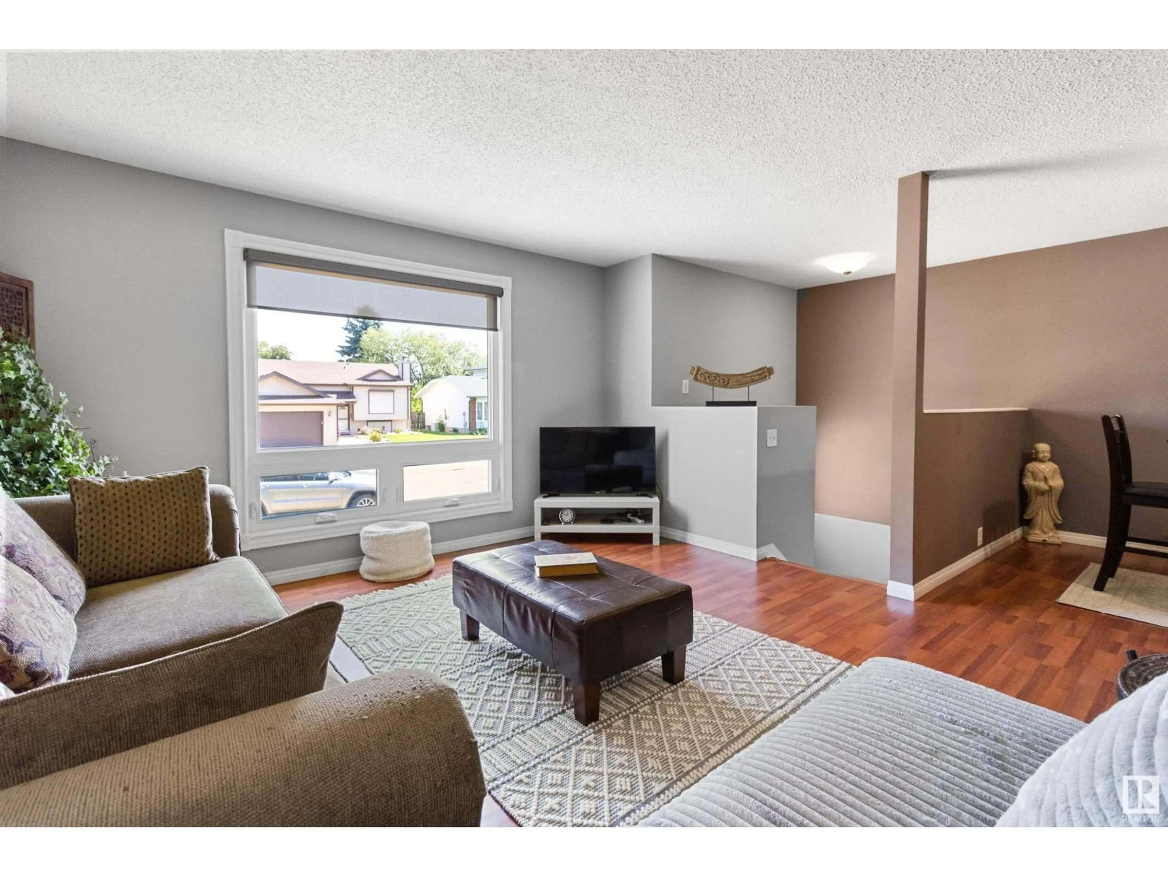 Living room with furniture, wood/laminate floor for 16 HOWSON CR, Edmonton Alberta T5A4V2