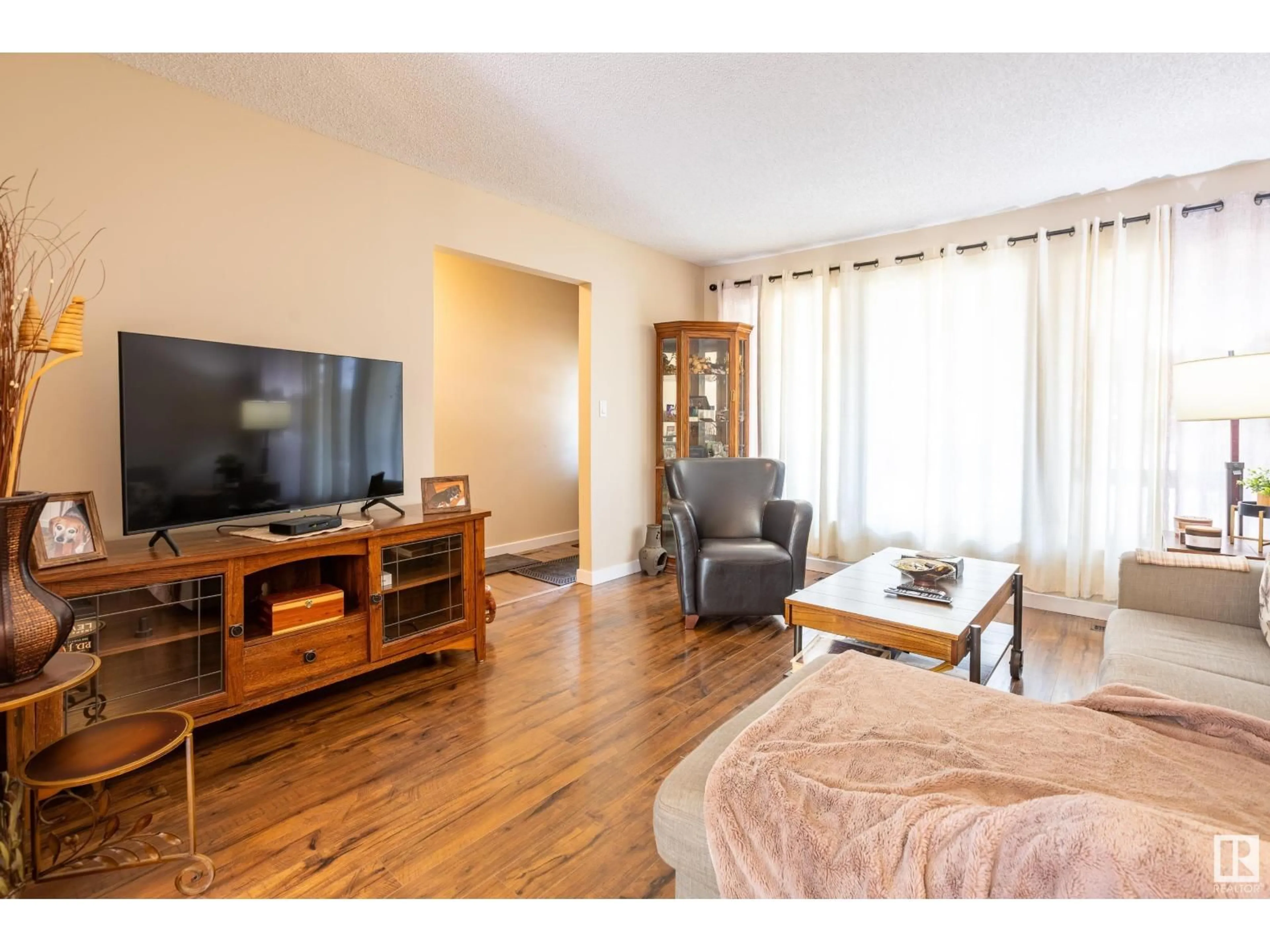 Living room with furniture, wood/laminate floor for 9008 99A AV, Morinville Alberta T8R1K3
