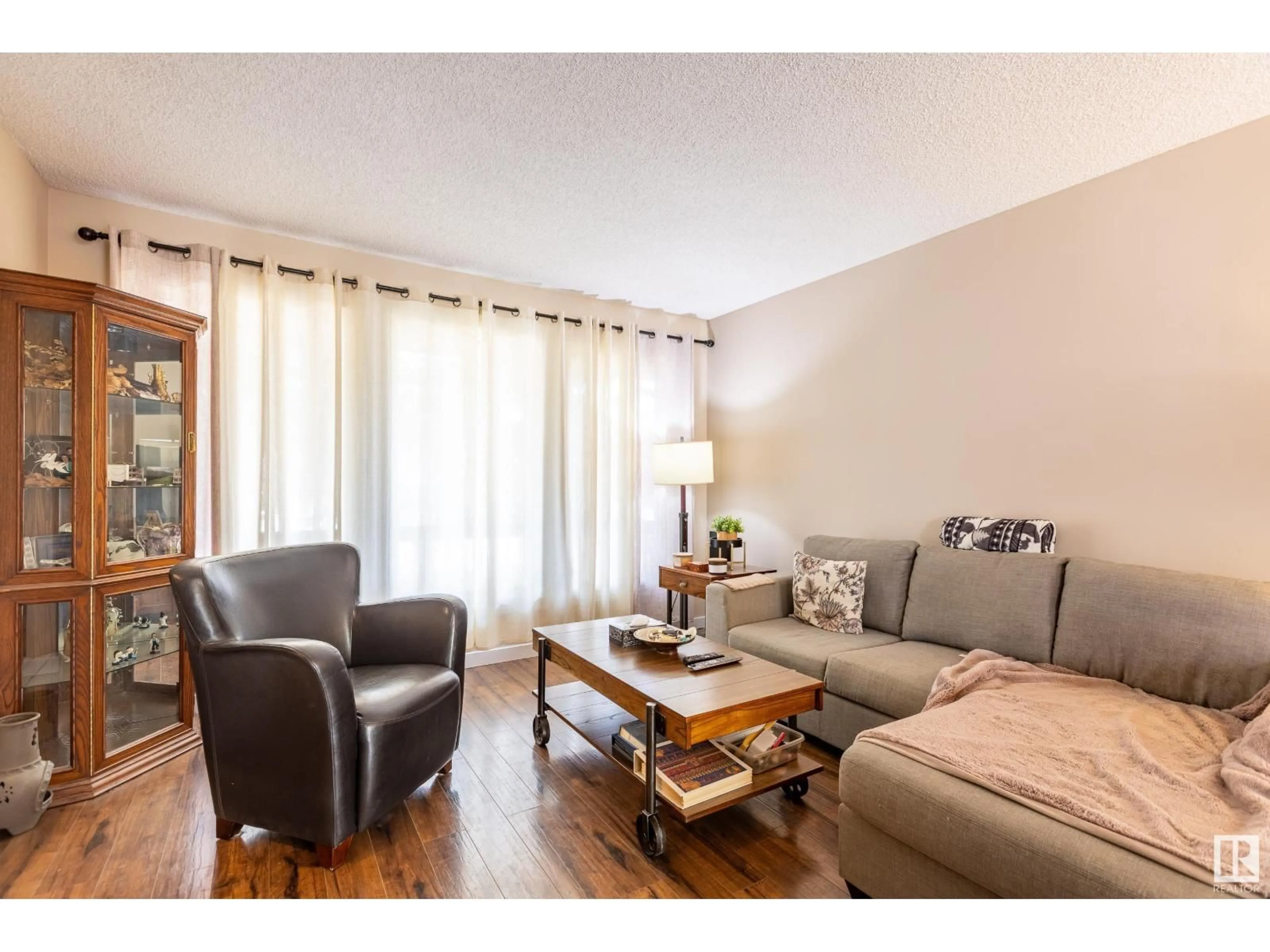 Living room with furniture, wood/laminate floor for 9008 99A AV, Morinville Alberta T8R1K3