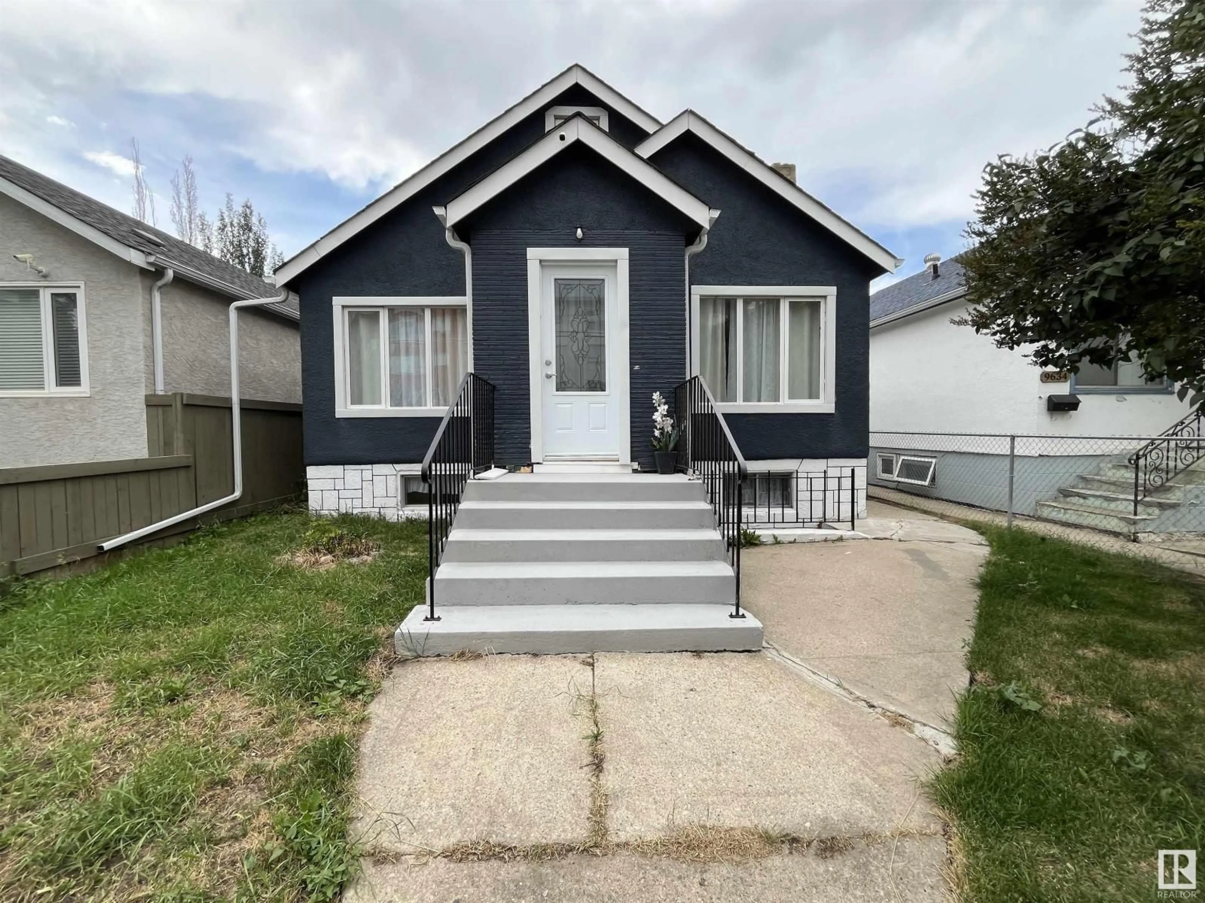 Home with vinyl exterior material, street for 9638 106 AV, Edmonton Alberta T5H0N4