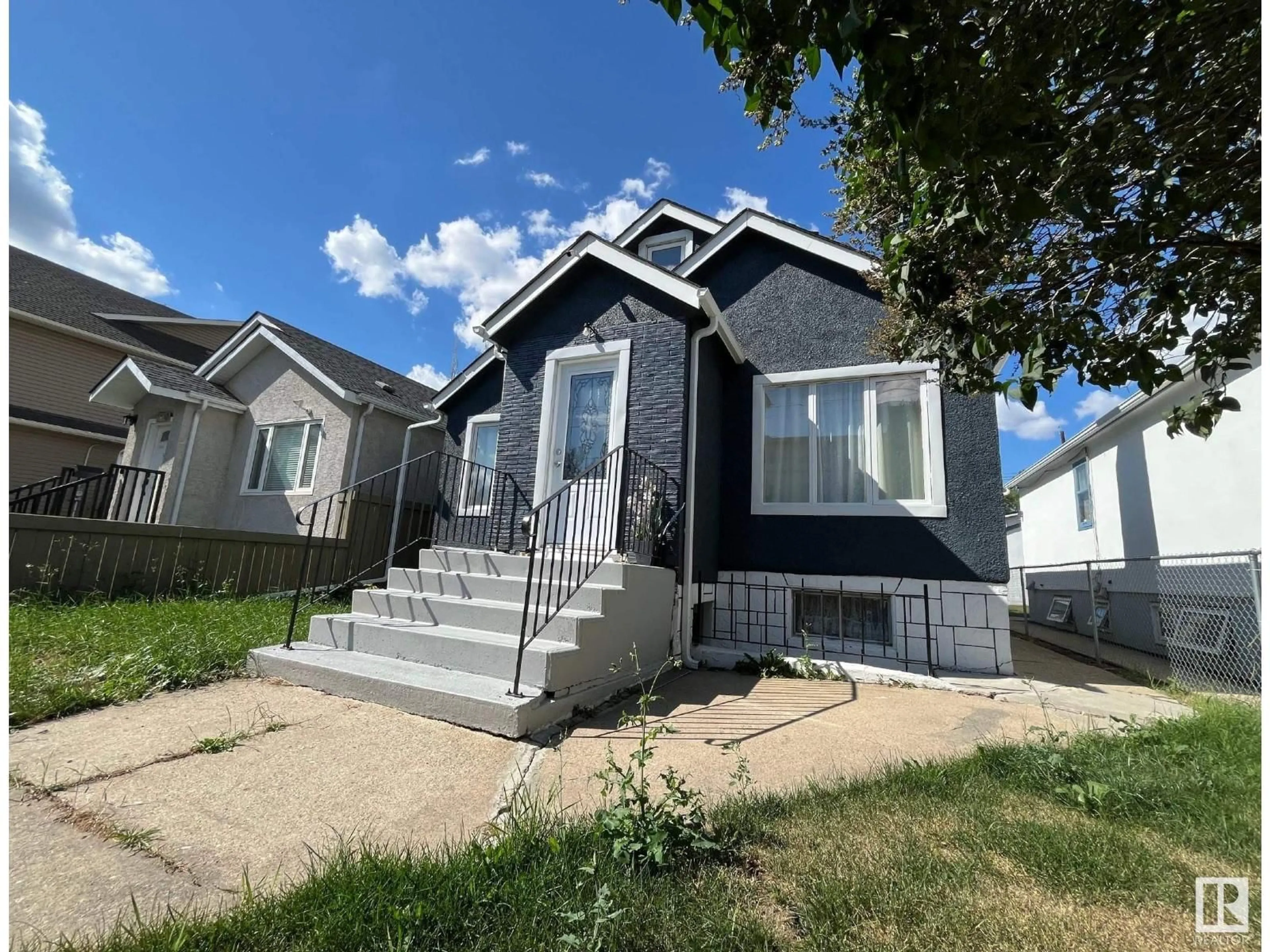 Home with vinyl exterior material, street for 9638 106 AV, Edmonton Alberta T5H0N4