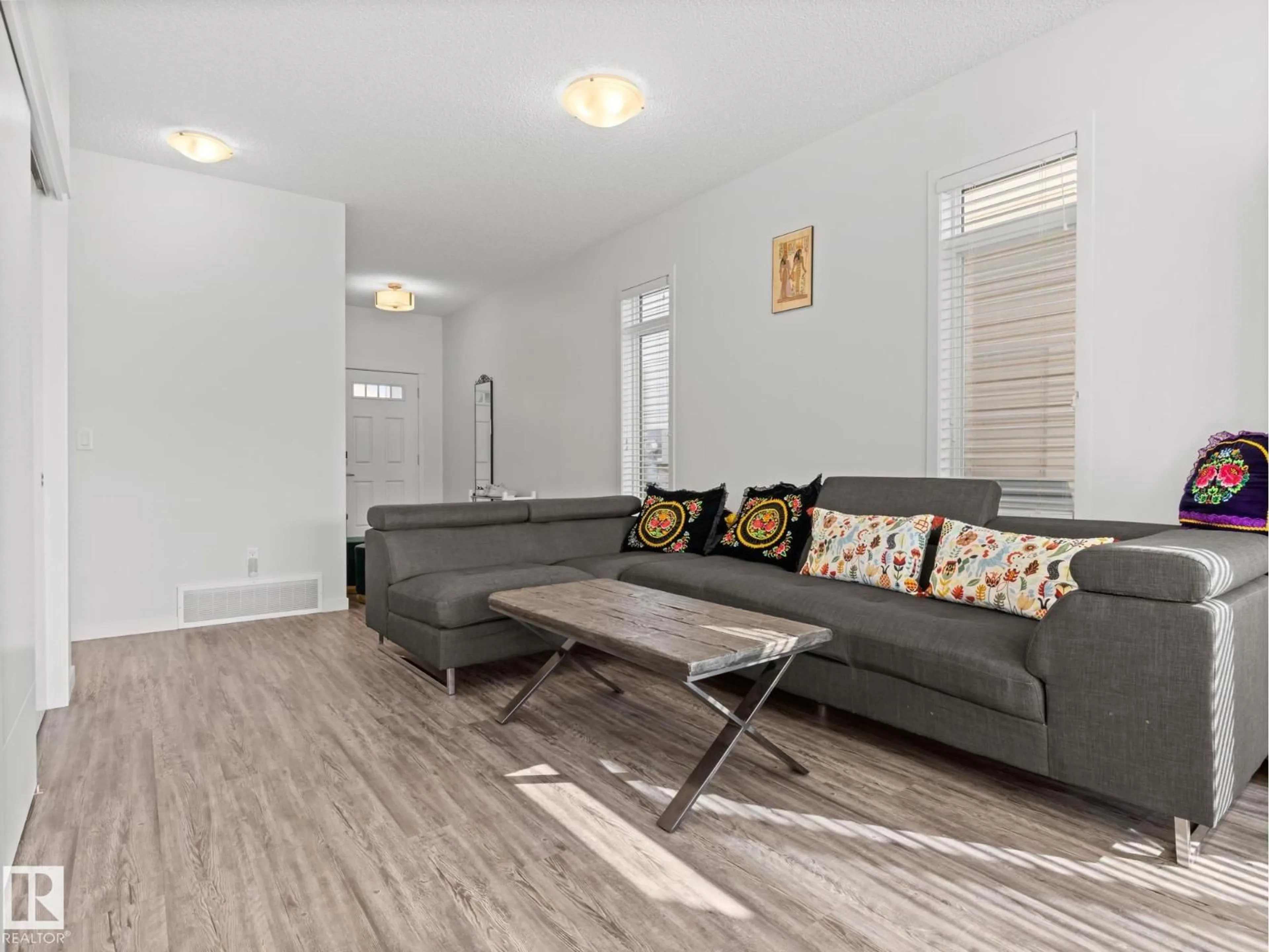 Living room with furniture, wood/laminate floor for 8743 CARSON WY, Edmonton Alberta T6W4A6