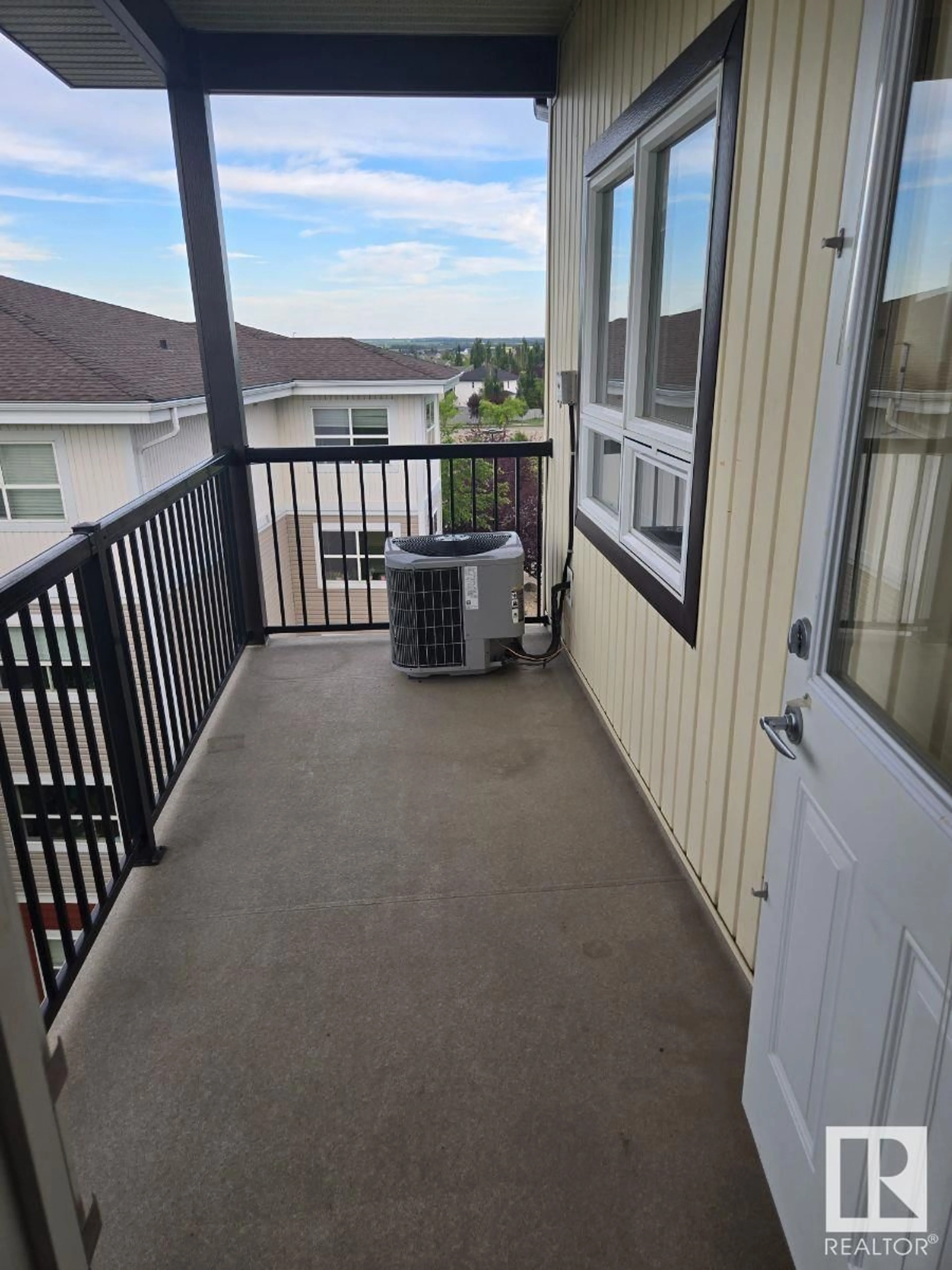 Balcony in the apartment, city buildings view from balcony for 405 - 8702 SOUTHFORT DR, Fort Saskatchewan Alberta T8L4R6