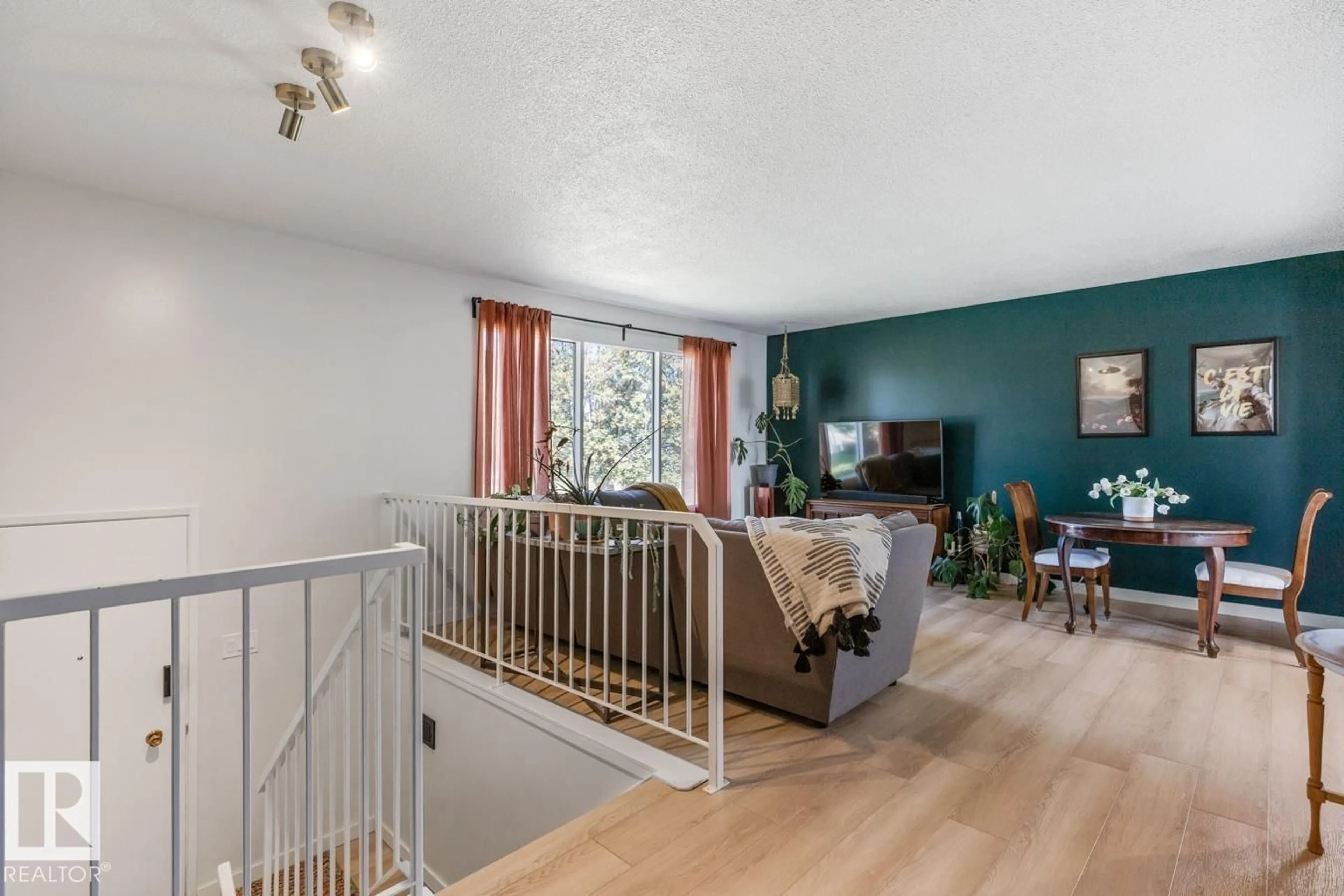 Living room with furniture, wood/laminate floor for 11119 34 ST, Edmonton Alberta T5W1Y8