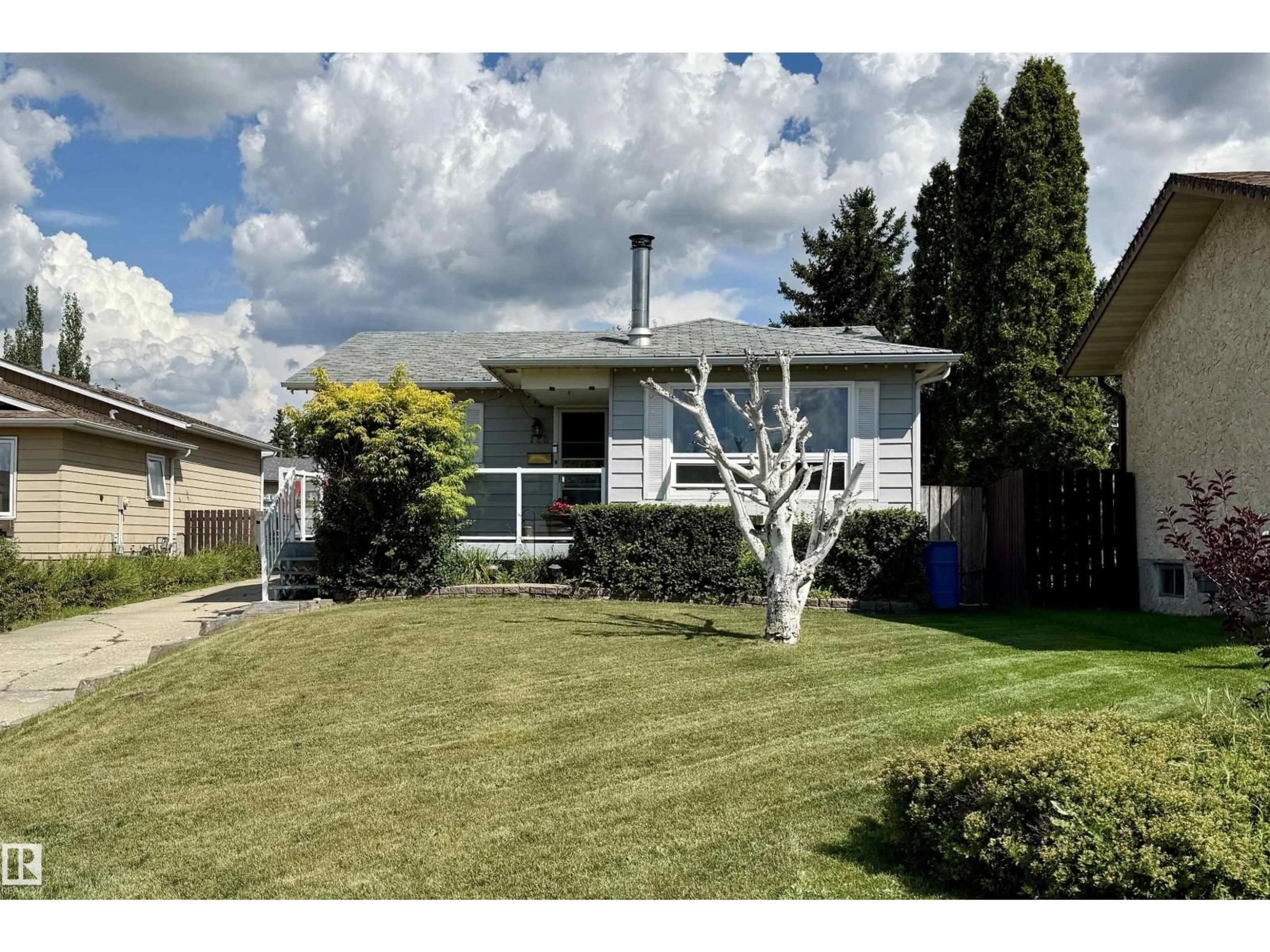 Home with vinyl exterior material, street for 128 WARWICK RD, Edmonton Alberta T5Y4P8