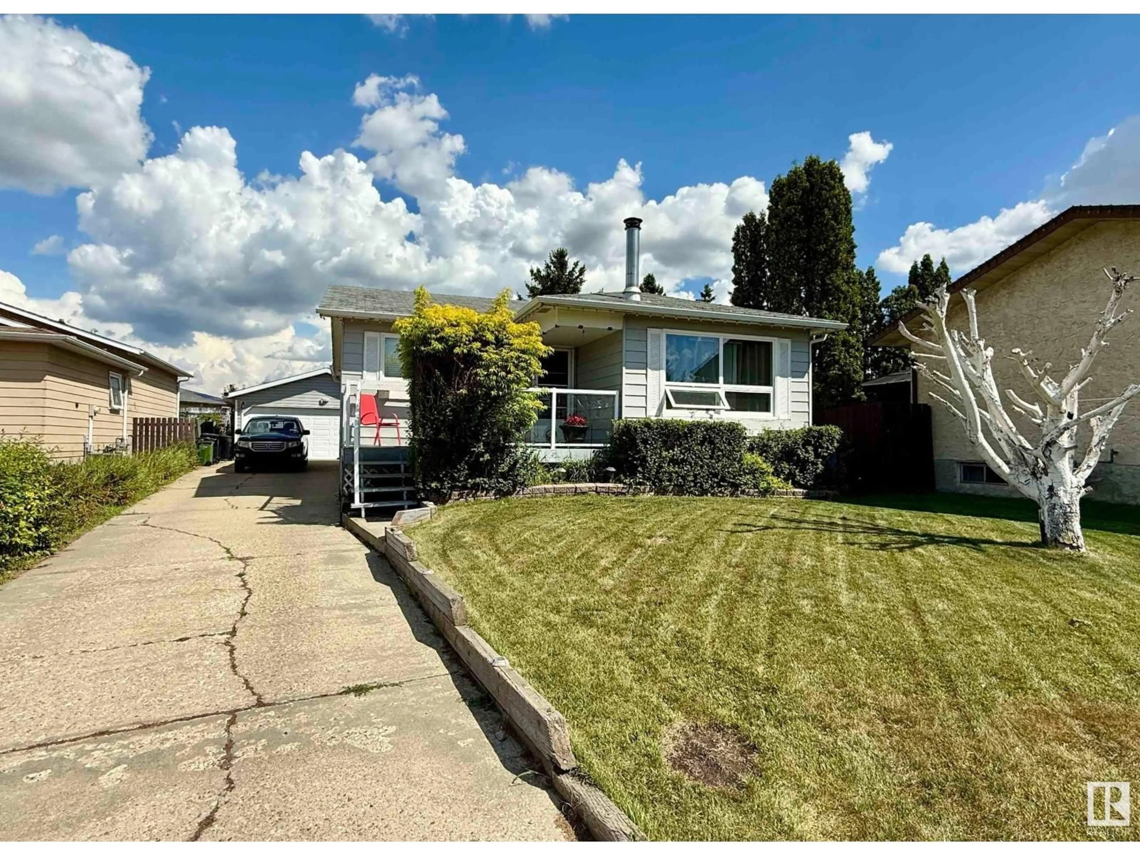 Home with vinyl exterior material, street for 128 WARWICK RD, Edmonton Alberta T5Y4P8