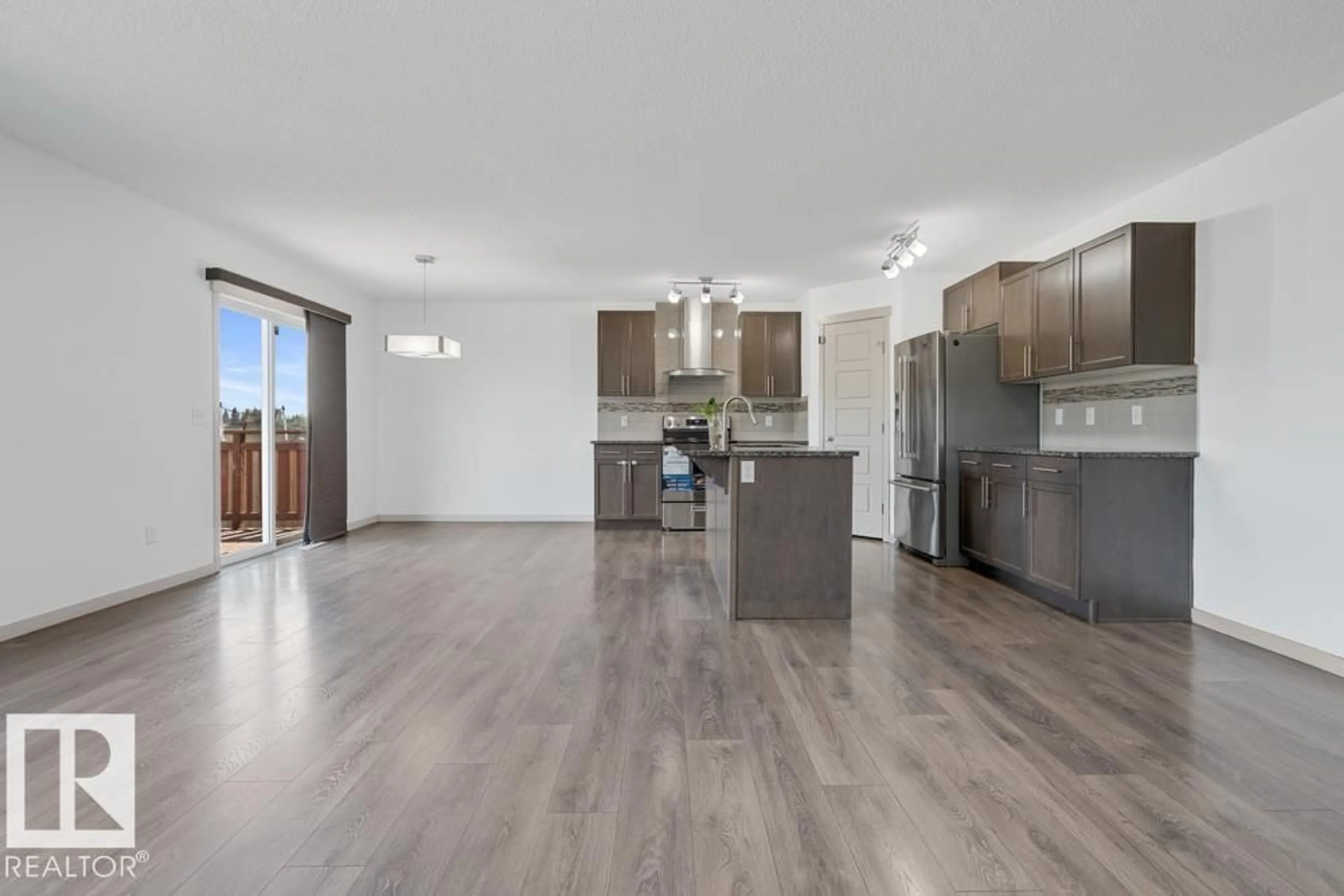 Open concept kitchen, wood/laminate floor for 2703 11 ST NW, Edmonton Alberta T6T0X9