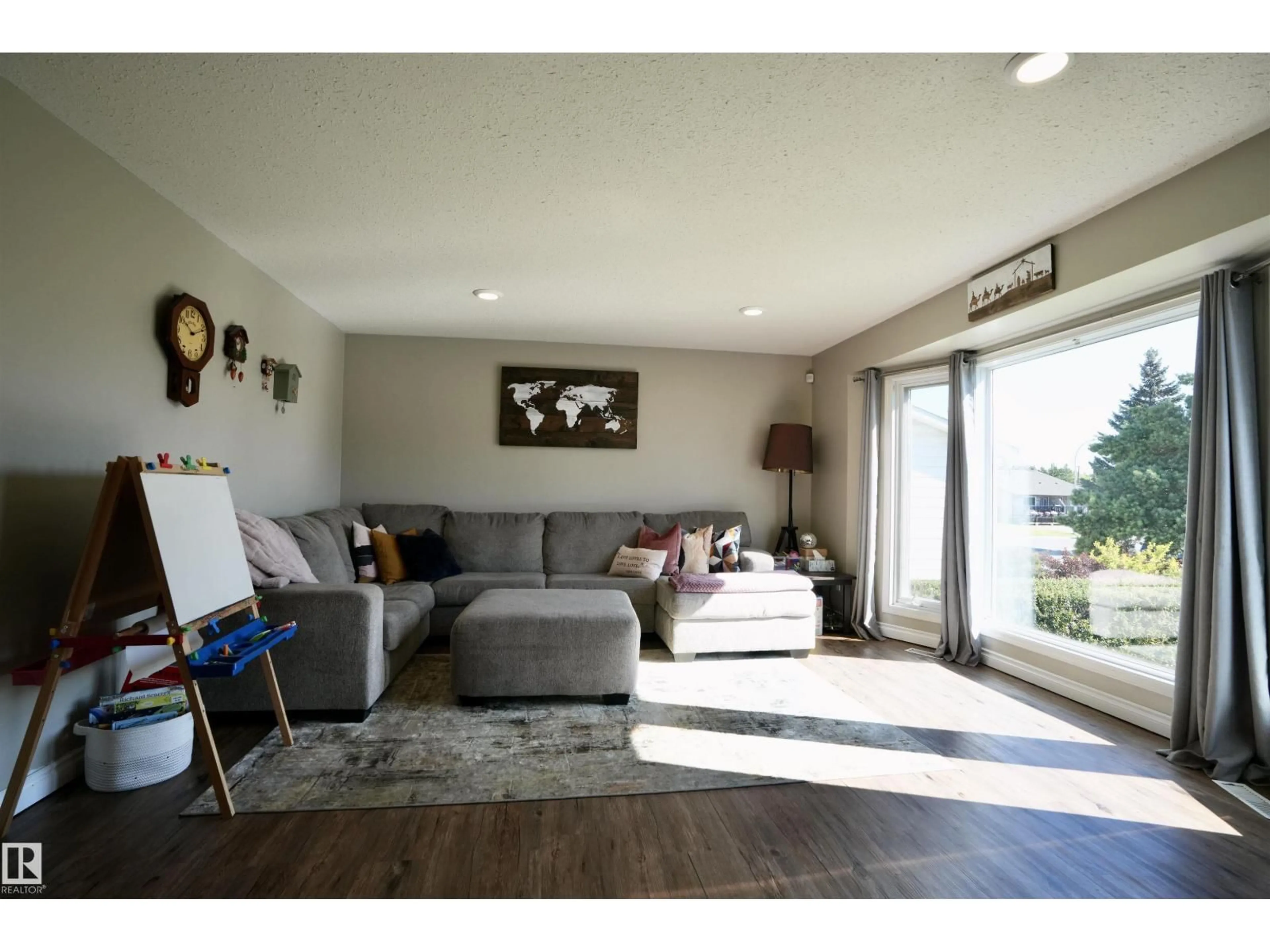 Living room with furniture, wood/laminate floor for 5214 56A ST, St. Paul Town Alberta T0A3A1