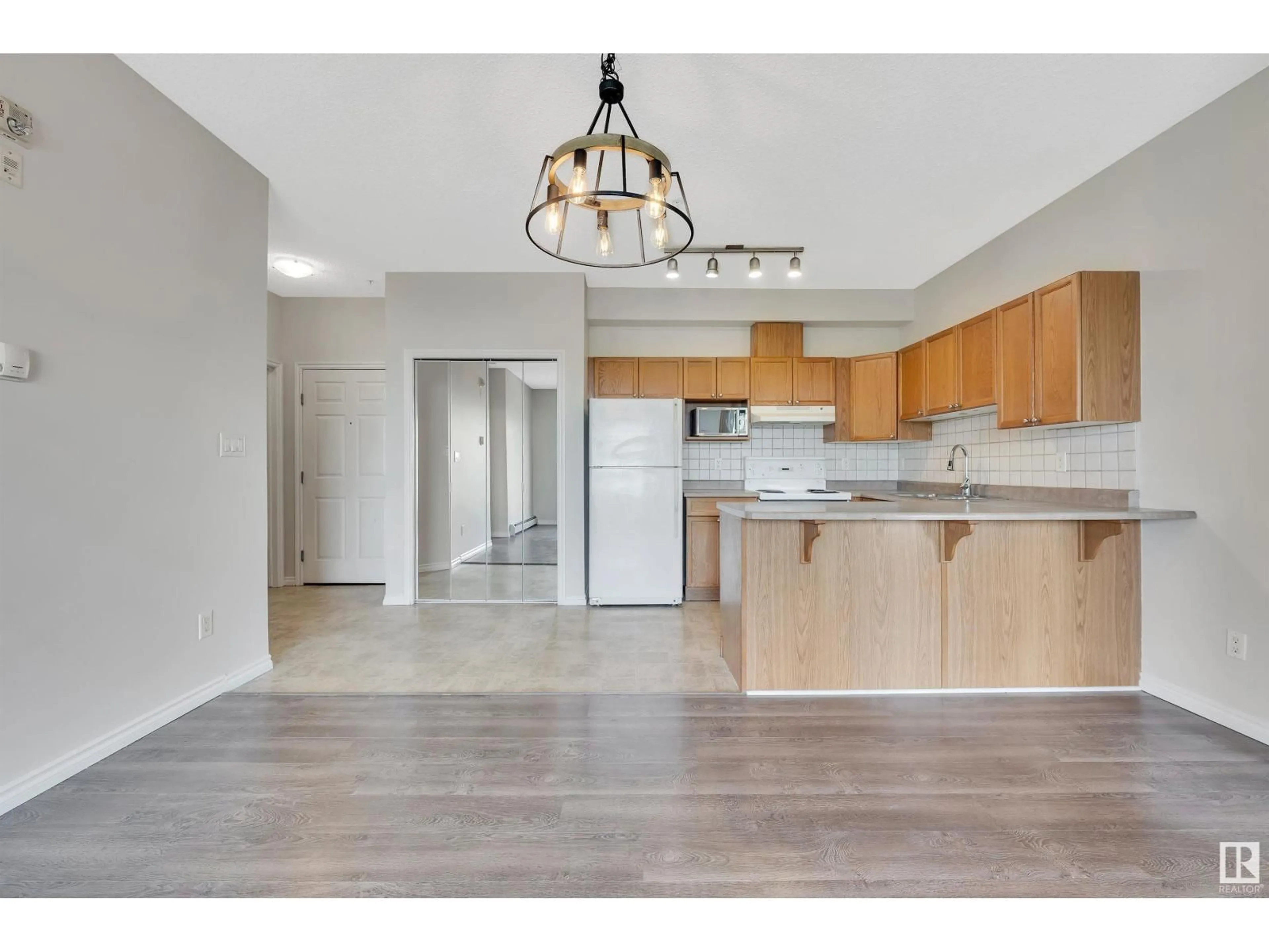 Open concept kitchen, wood/laminate floor for #308 - 10118 95 ST, Edmonton Alberta T5H4R6