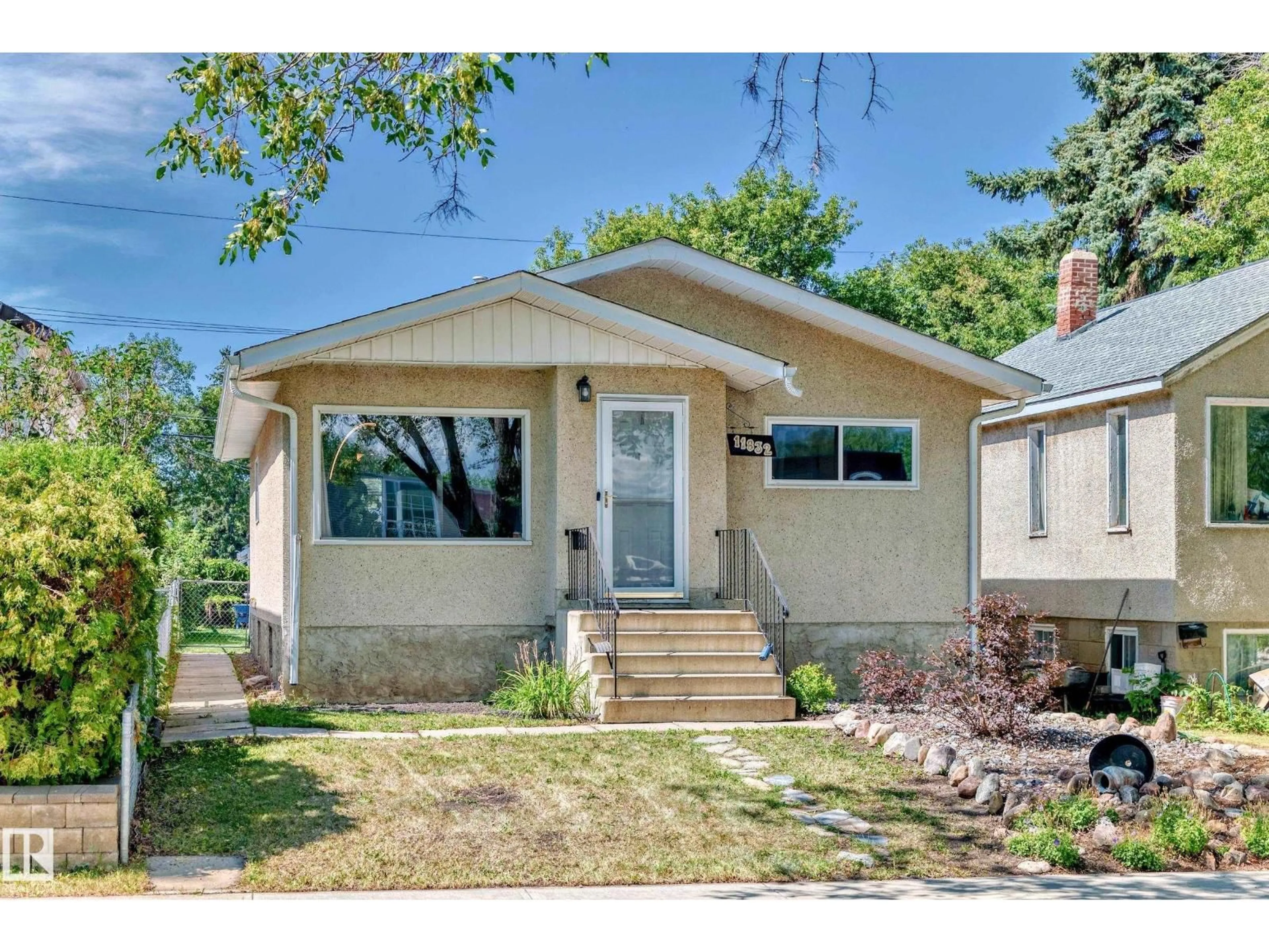 Home with vinyl exterior material, street for NW - 11832 64 ST, Edmonton Alberta T5W4J1