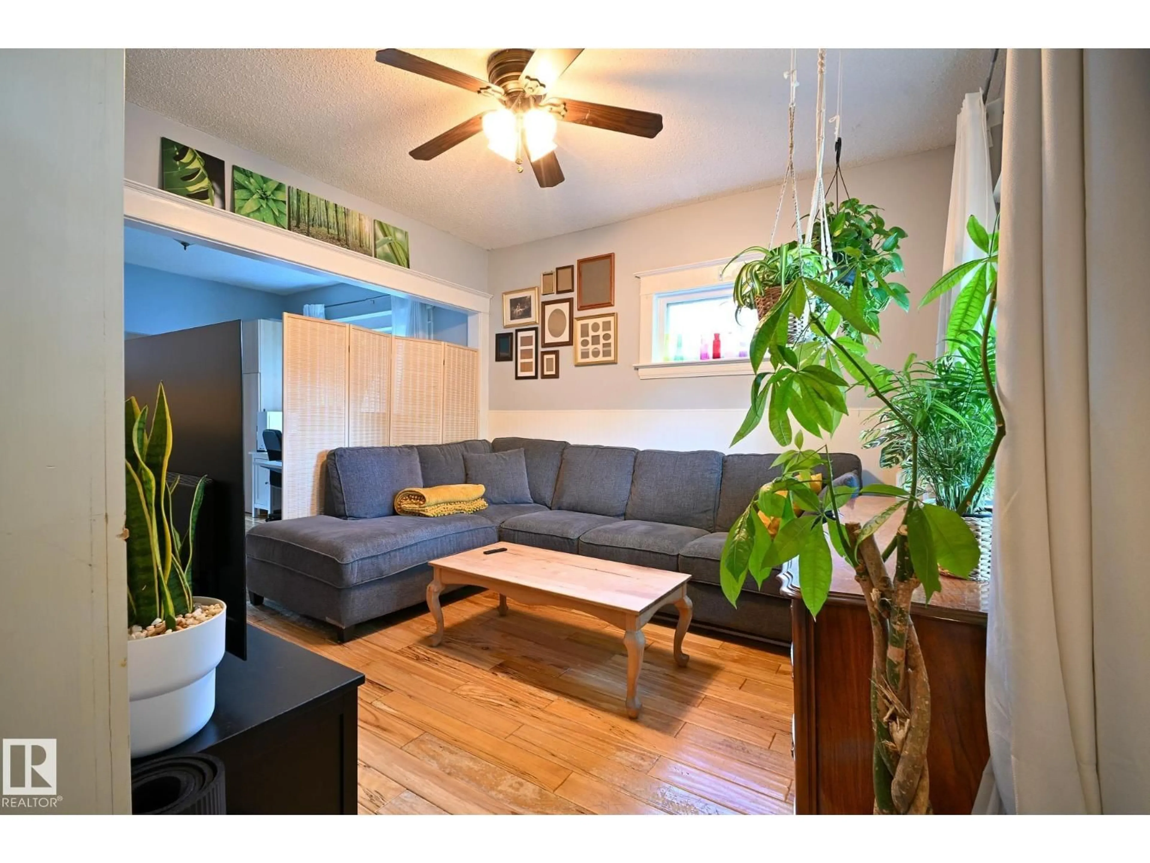 Living room with furniture, wood/laminate floor for 11711 96 ST, Edmonton Alberta T5G1V1