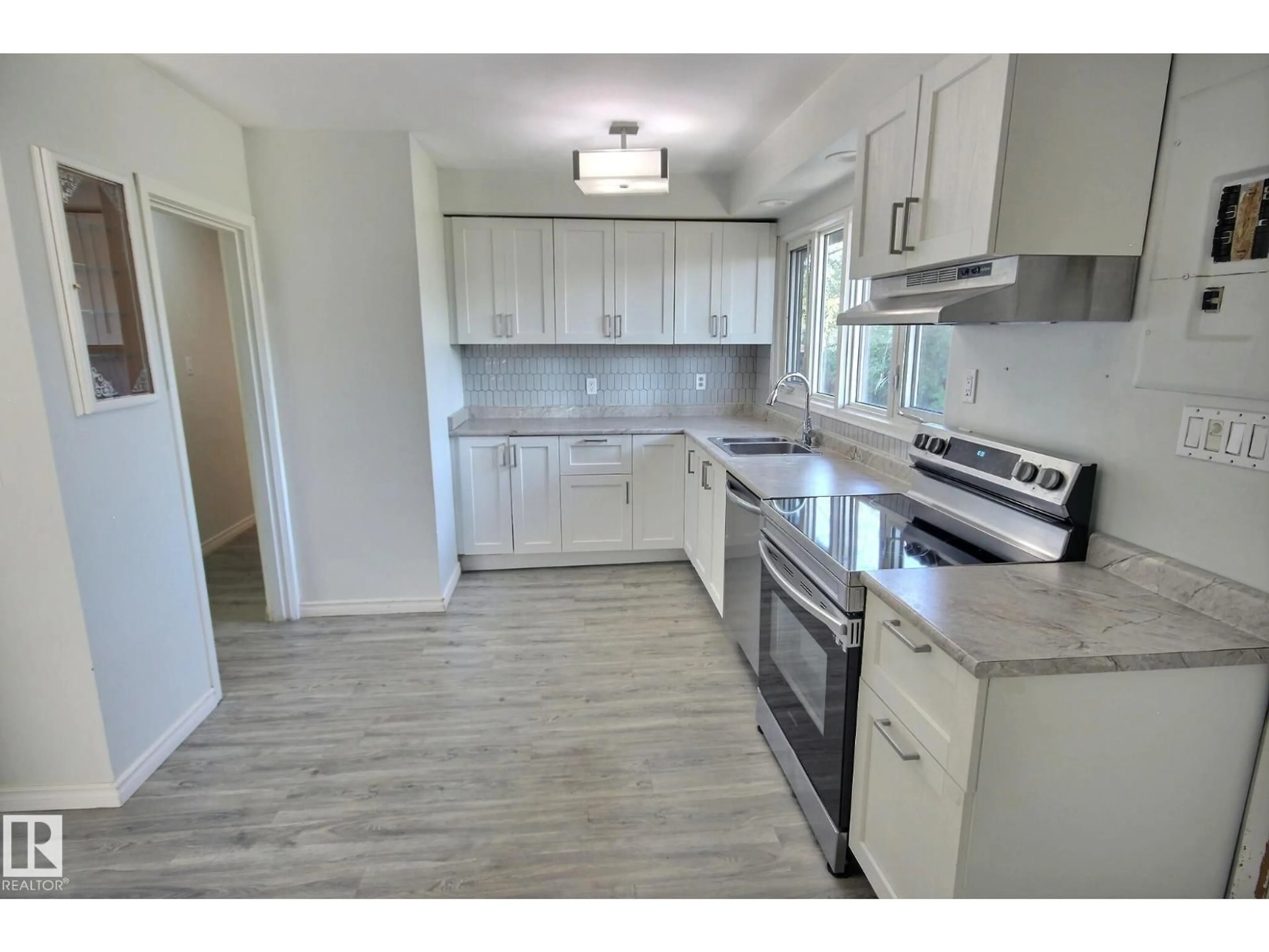 Open concept kitchen, wood/laminate floor for 16518 106 AV, Edmonton Alberta T5P0W9