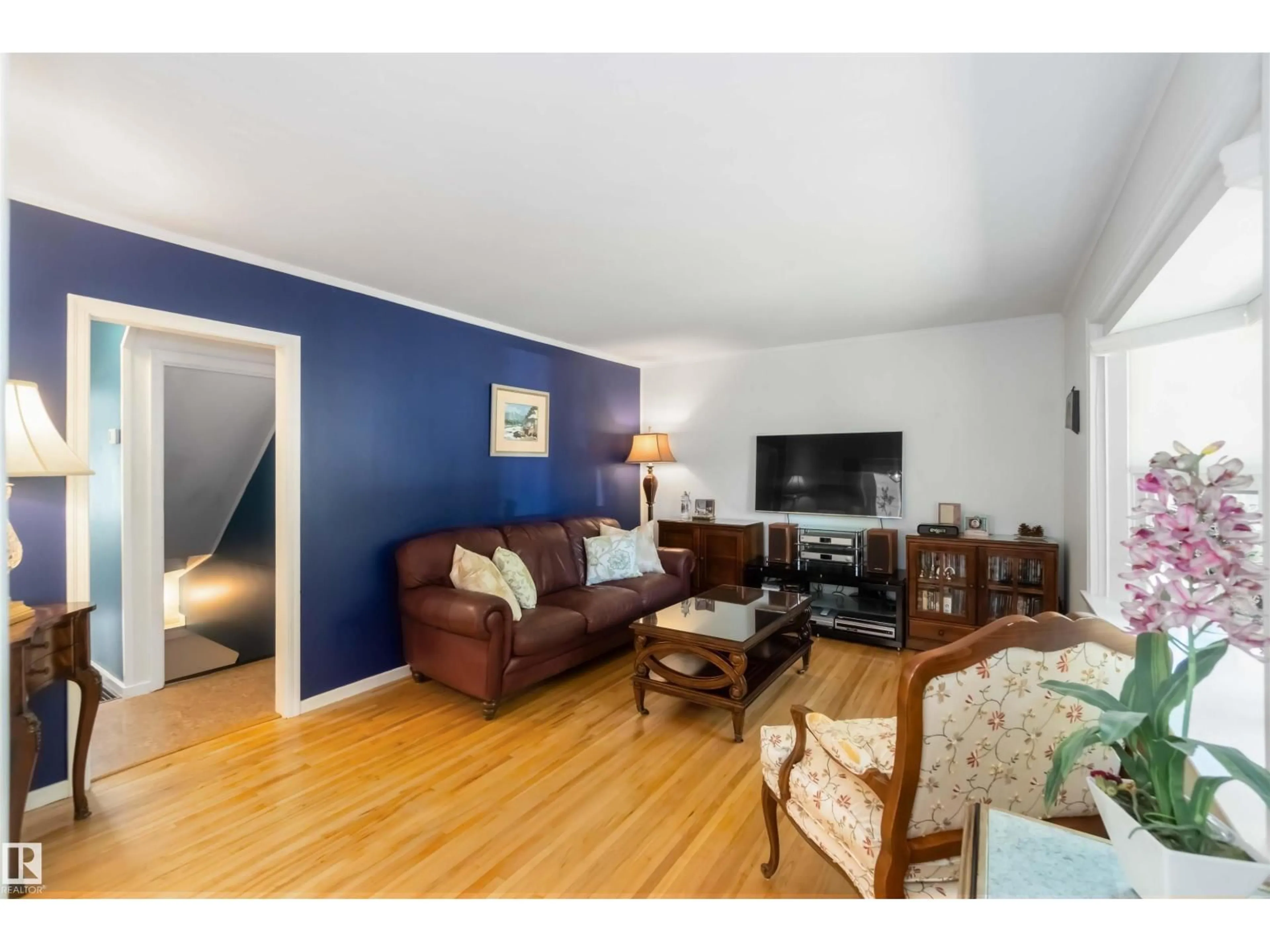 Living room with furniture, wood/laminate floor for 9347 73 AV, Edmonton Alberta T6E1A8