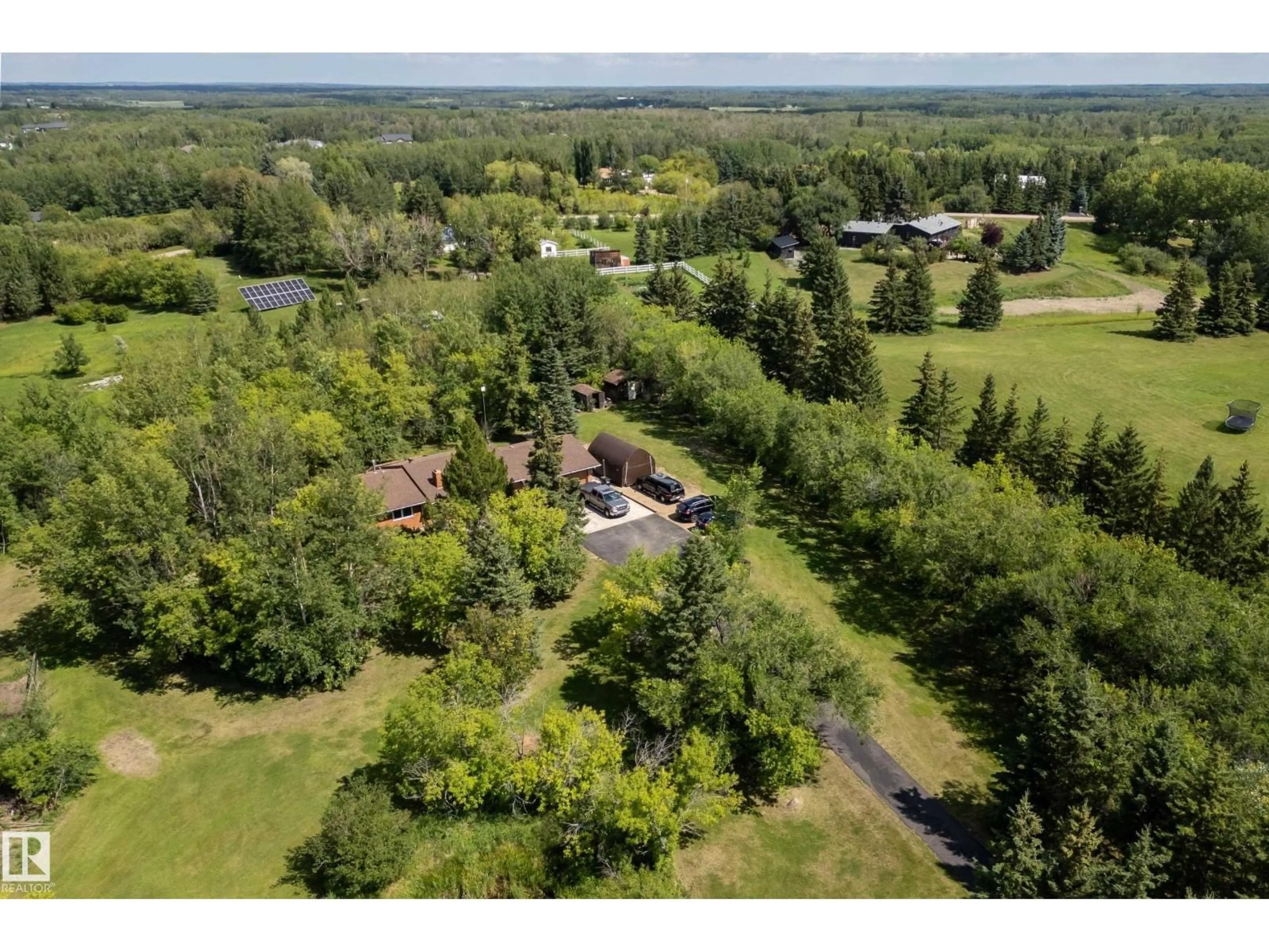 A pic from outside/outdoor area/front of a property/back of a property/a pic from drone, forest/trees view for #14 - 52063 RGE ROAD 225, Rural Strathcona County Alberta T8C1C3