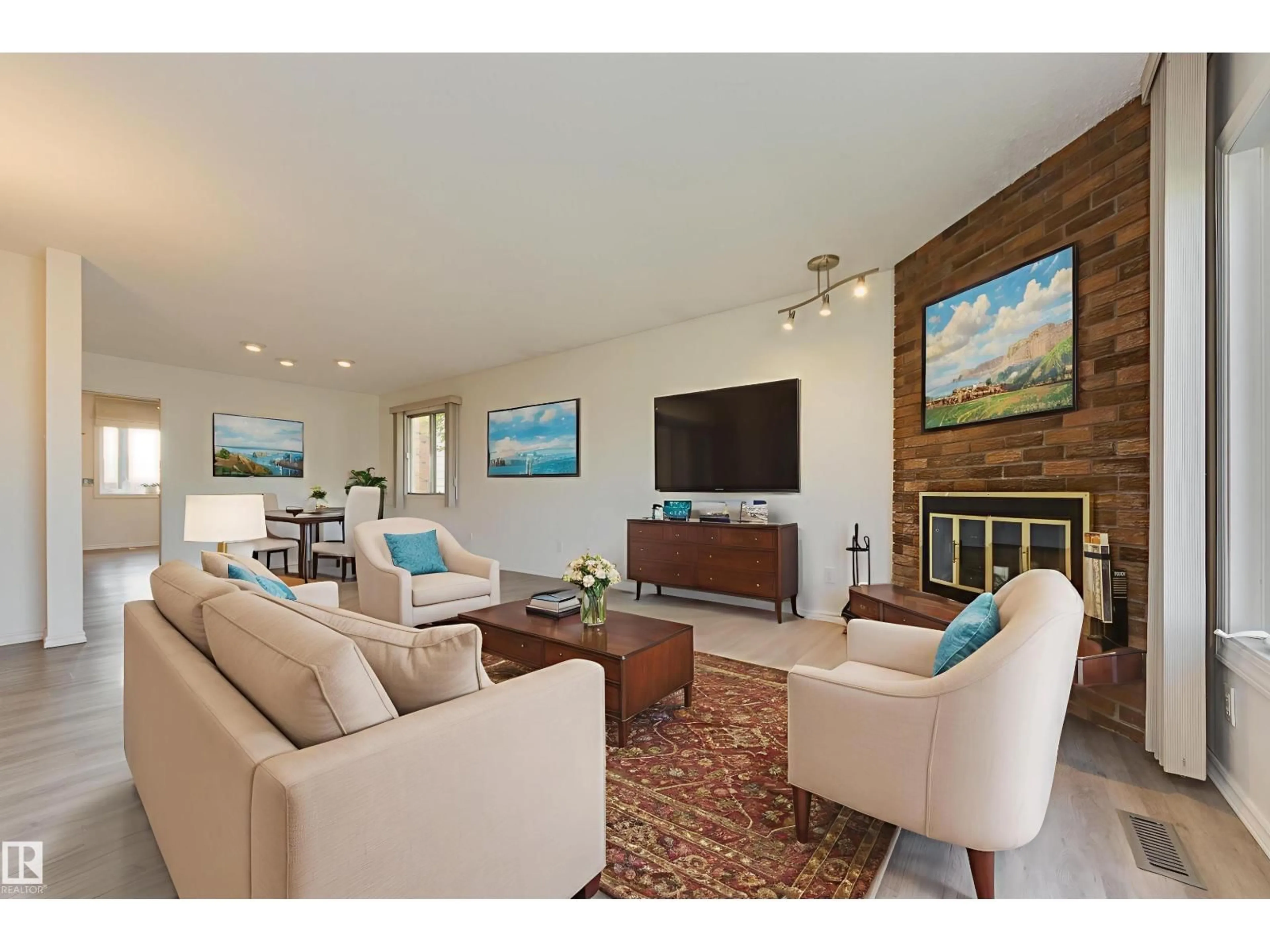 Living room with furniture, wood/laminate floor for 8504 151 AV, Edmonton Alberta T5E5X1