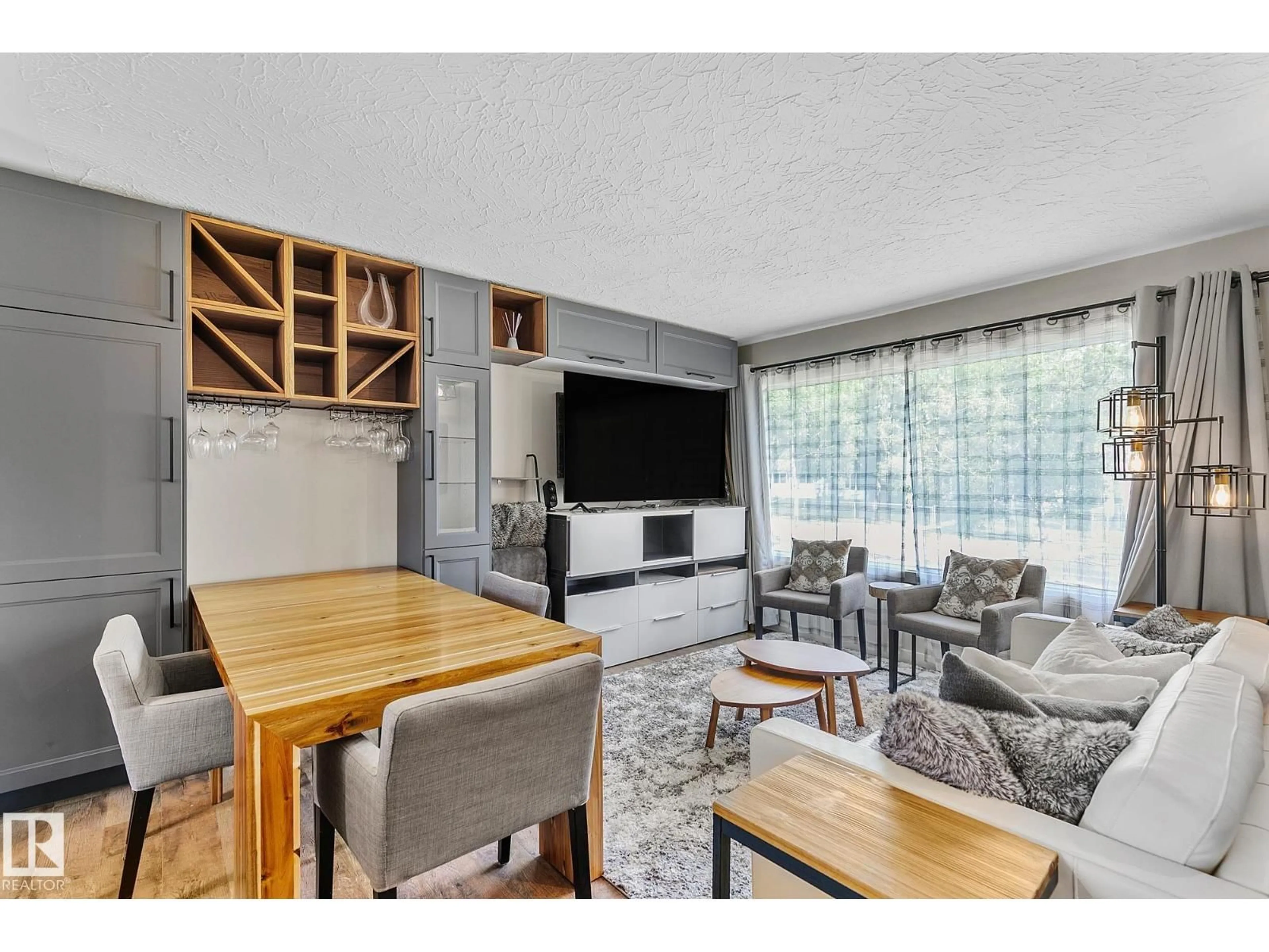 Living room with furniture, wood/laminate floor for 7531 76 AV, Edmonton Alberta T6C0H3
