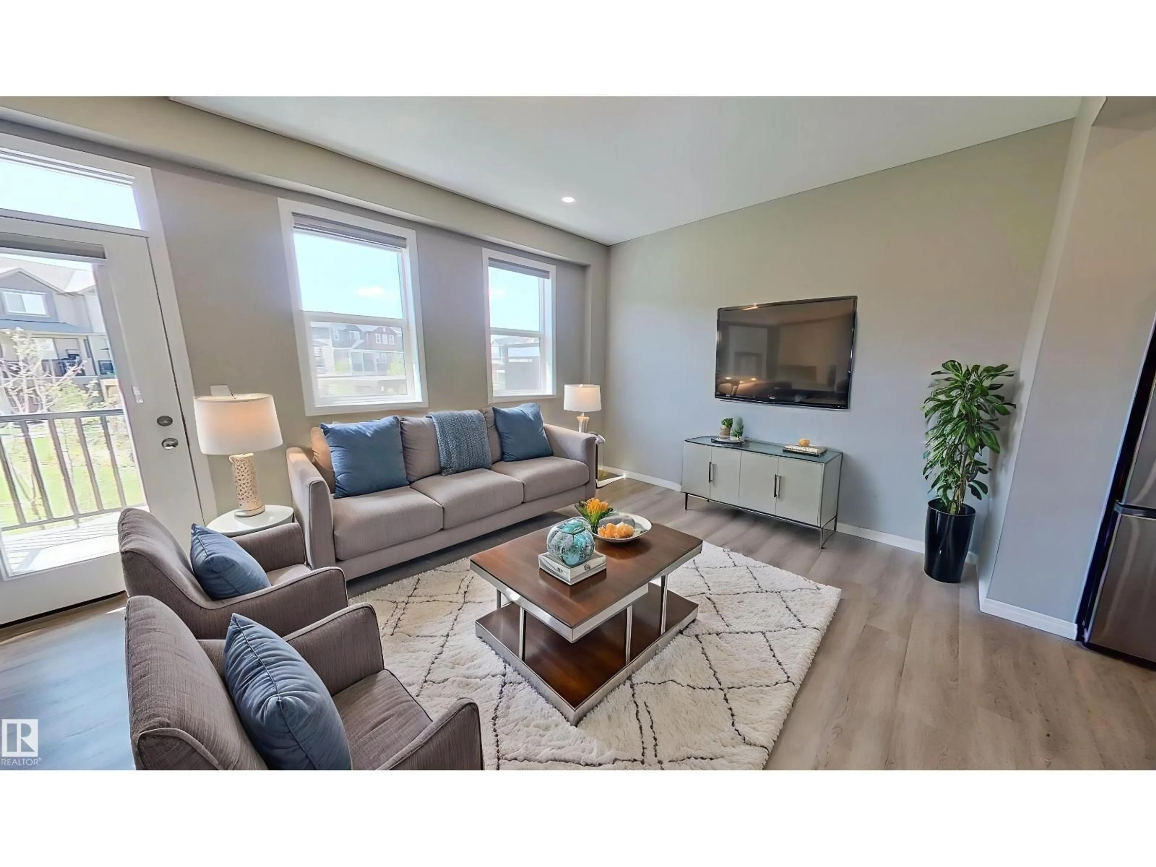 Living room with furniture, unknown for #105 - 2072 WONNACOTT WY, Edmonton Alberta T6X2V7