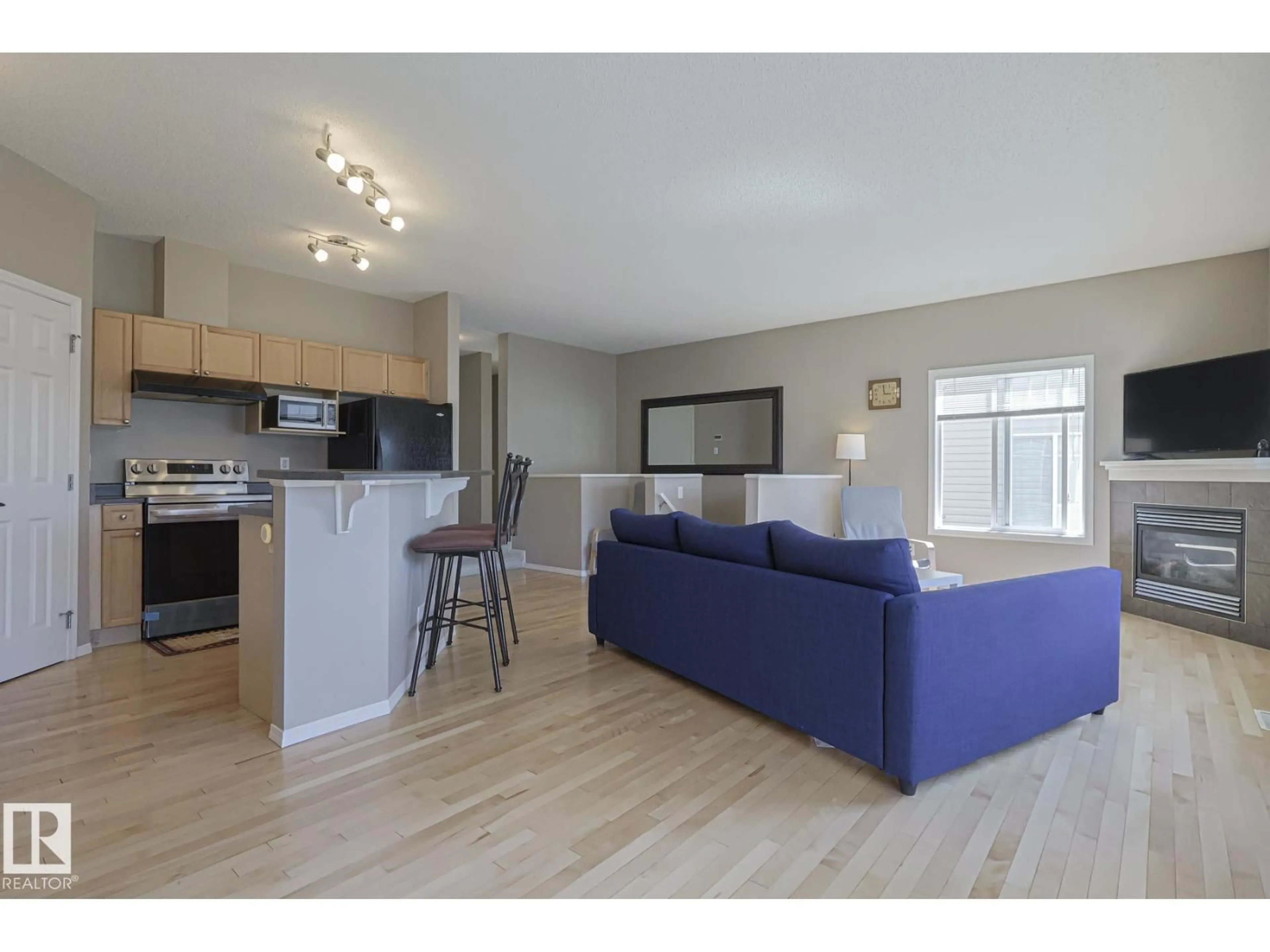 Living room with furniture, wood/laminate floor for #31 - 2508 HANNA CR, Edmonton Alberta T6R3N7