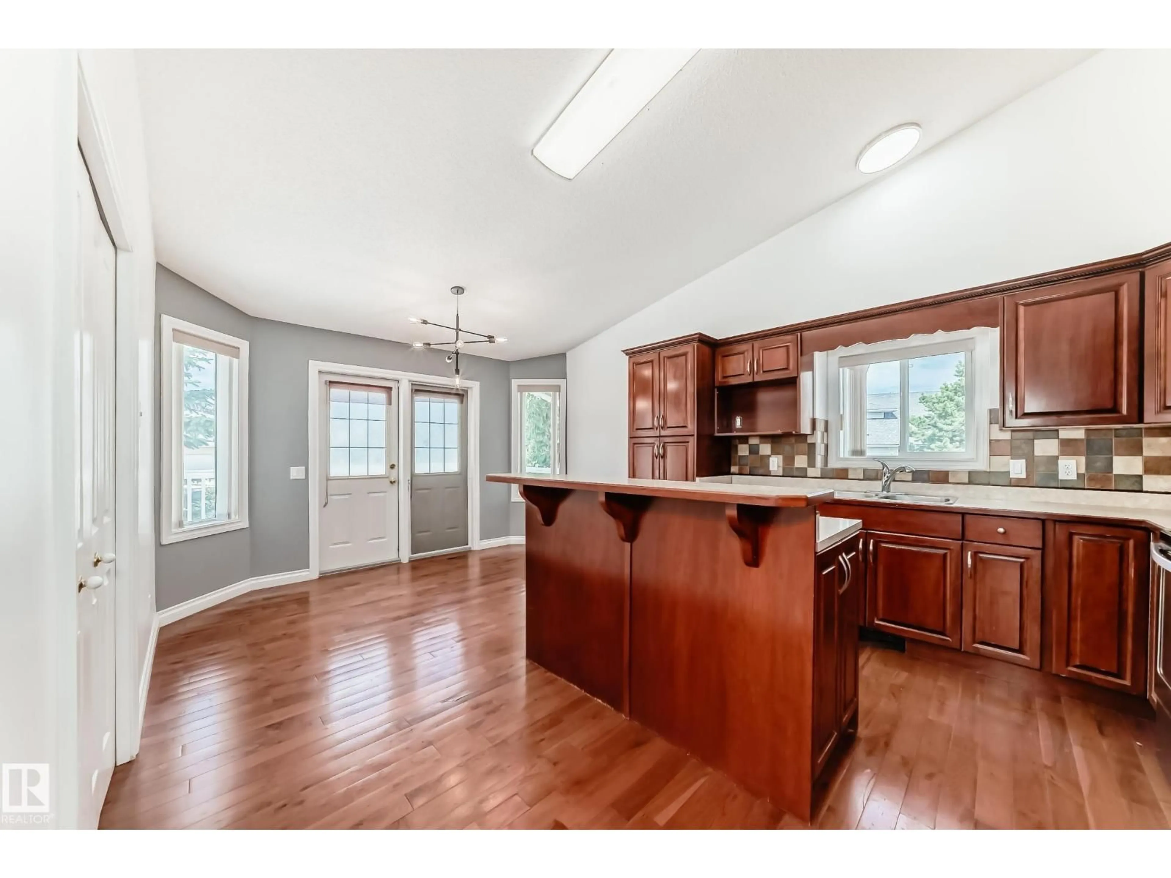 Open concept kitchen, wood/laminate floor for 3832 41 ST, Edmonton Alberta T6L6R5