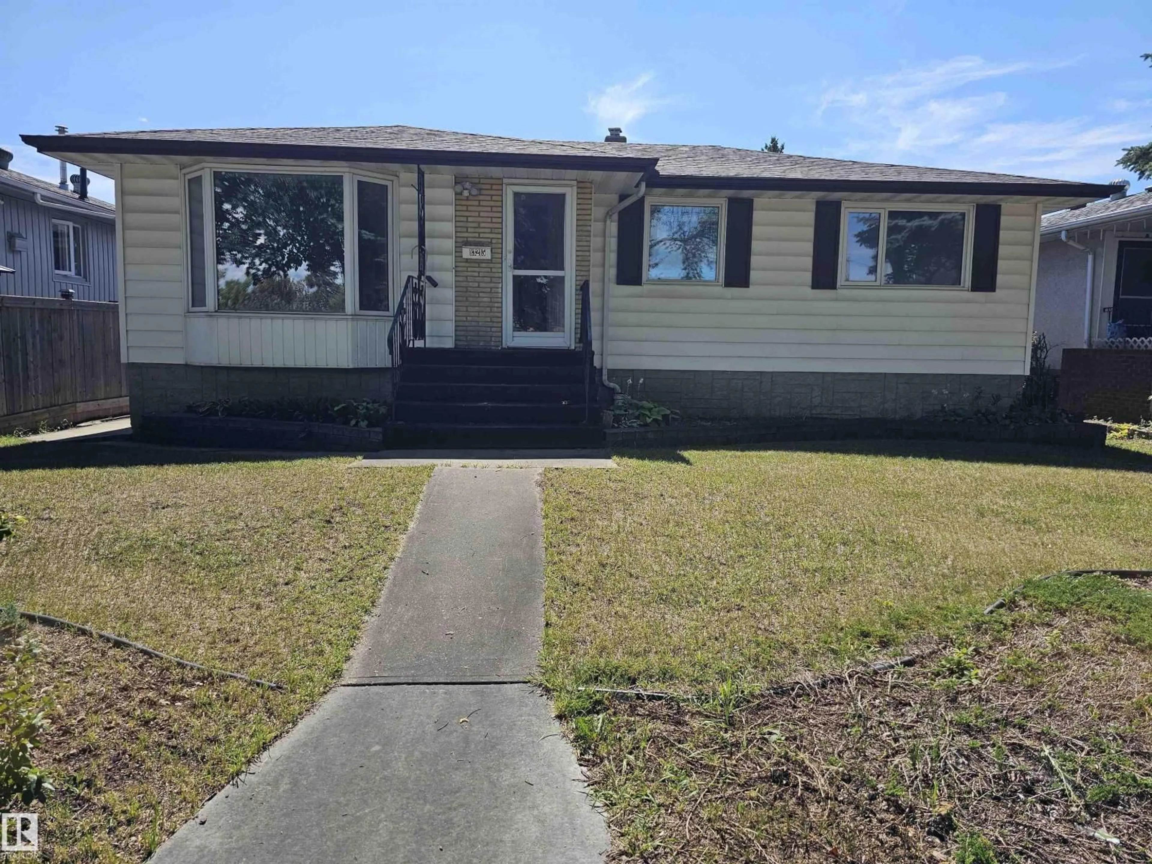 Home with vinyl exterior material, street for 13215 116 AV, Edmonton Alberta T5M3E1