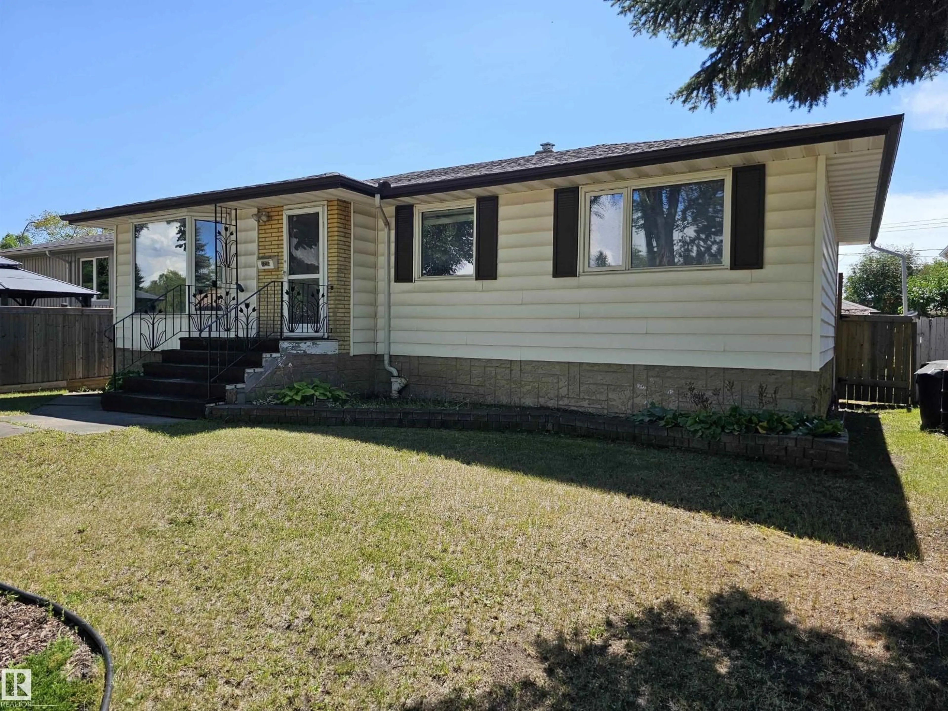 Home with vinyl exterior material, street for 13215 116 AV, Edmonton Alberta T5M3E1