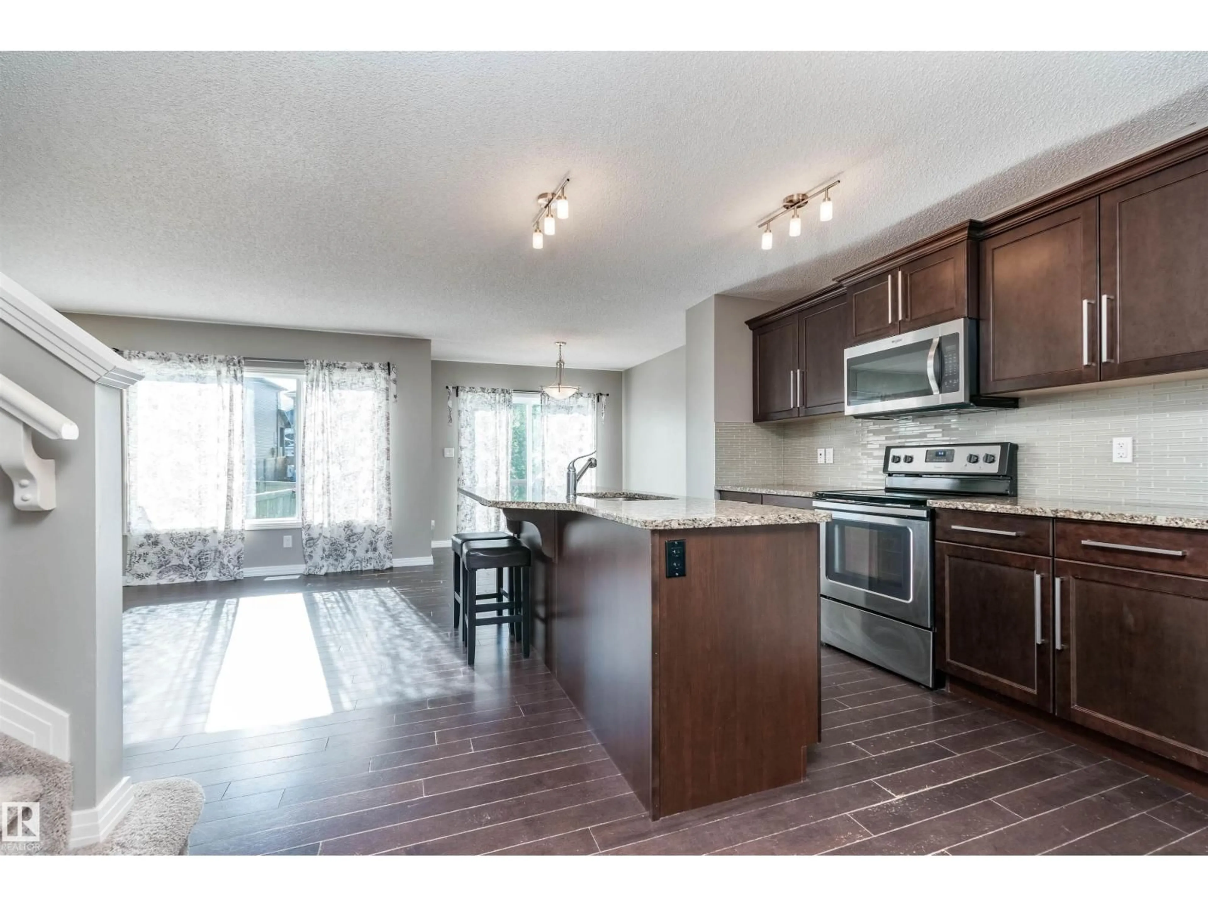 Open concept kitchen, wood/laminate floor for NW - 4429 5A ST, Edmonton Alberta T6T0Z8