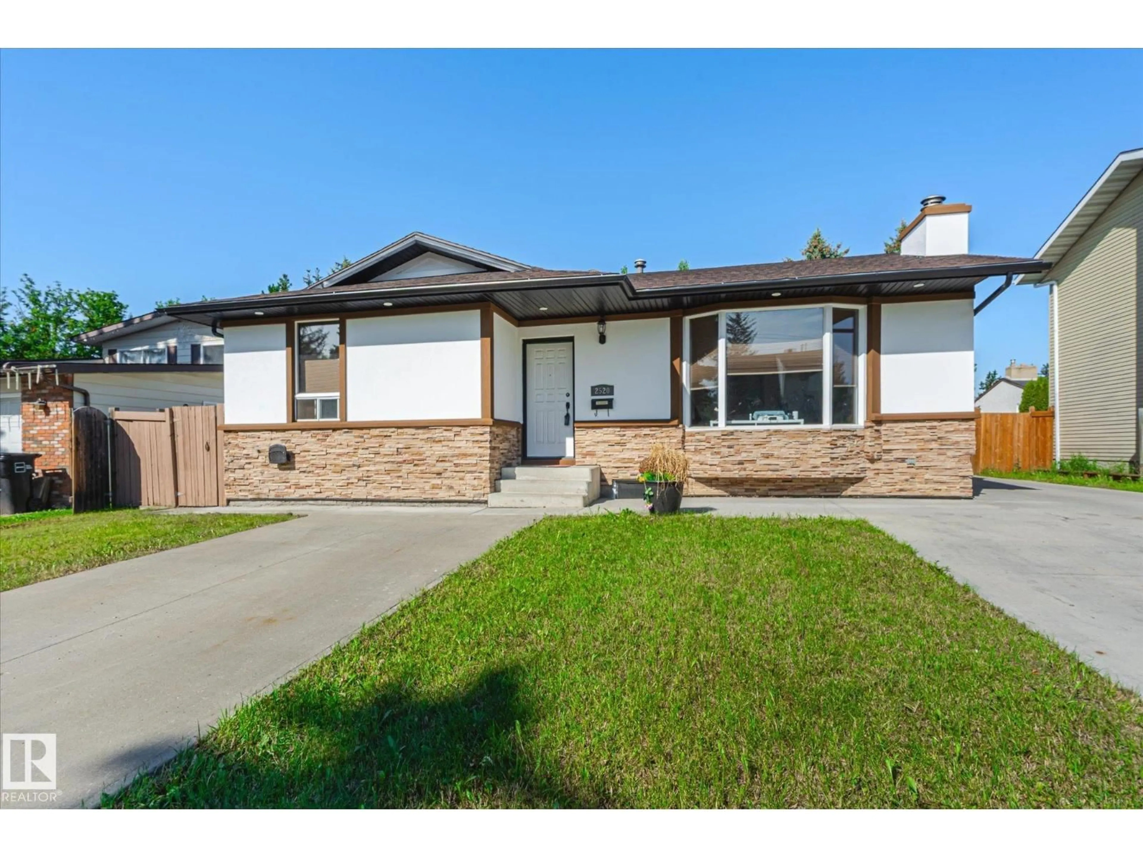 Home with vinyl exterior material, street for NW - 2520 116 ST, Edmonton Alberta T6J3S2