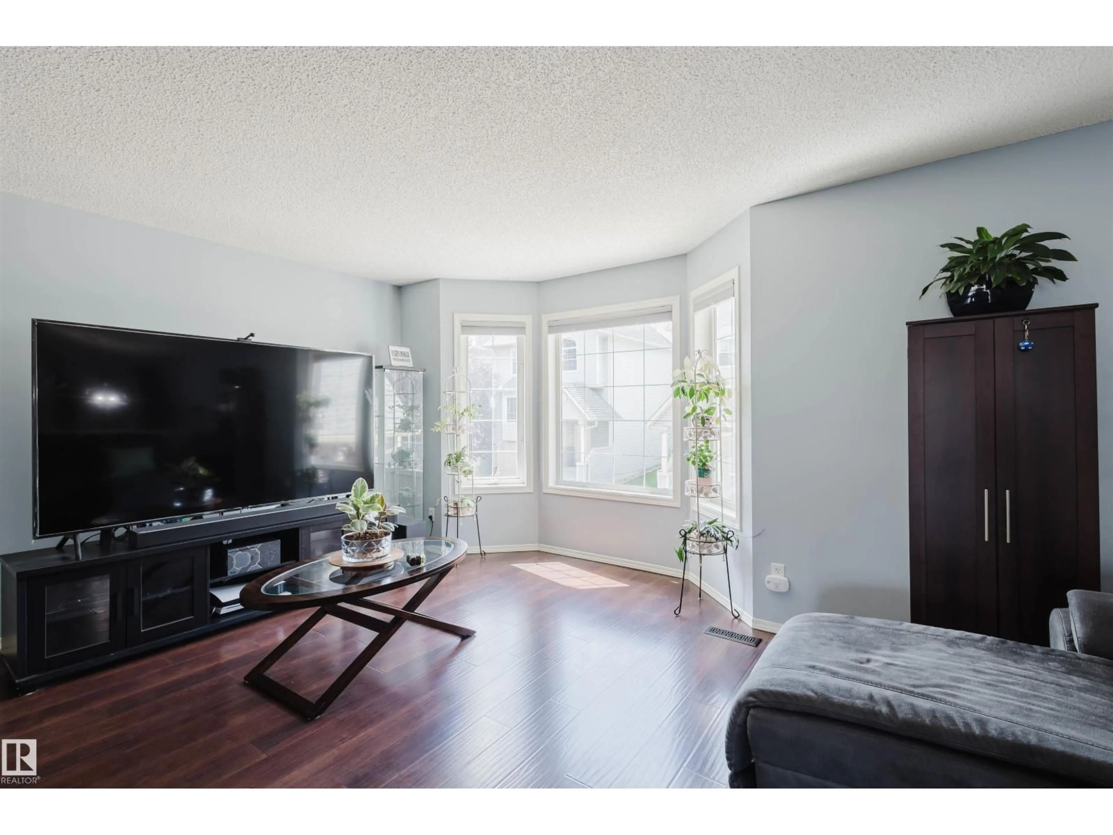 Living room with furniture, wood/laminate floor for #108 - 1670 JAMHA RD, Edmonton Alberta T6L7B3