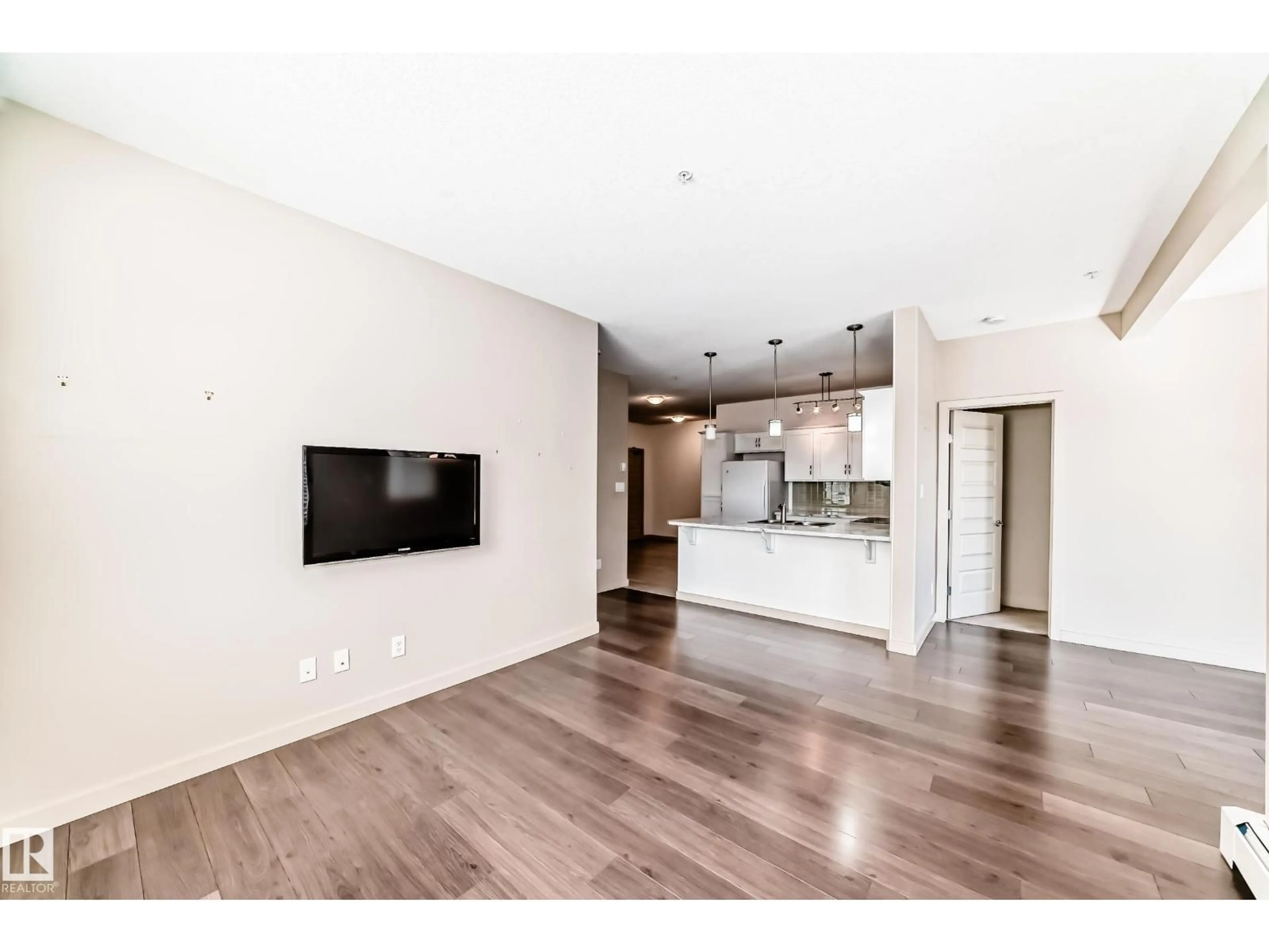 Open concept kitchen, wood/laminate floor for #202 - 304 AMBLESIDE LINK, Edmonton Alberta T6W0V2