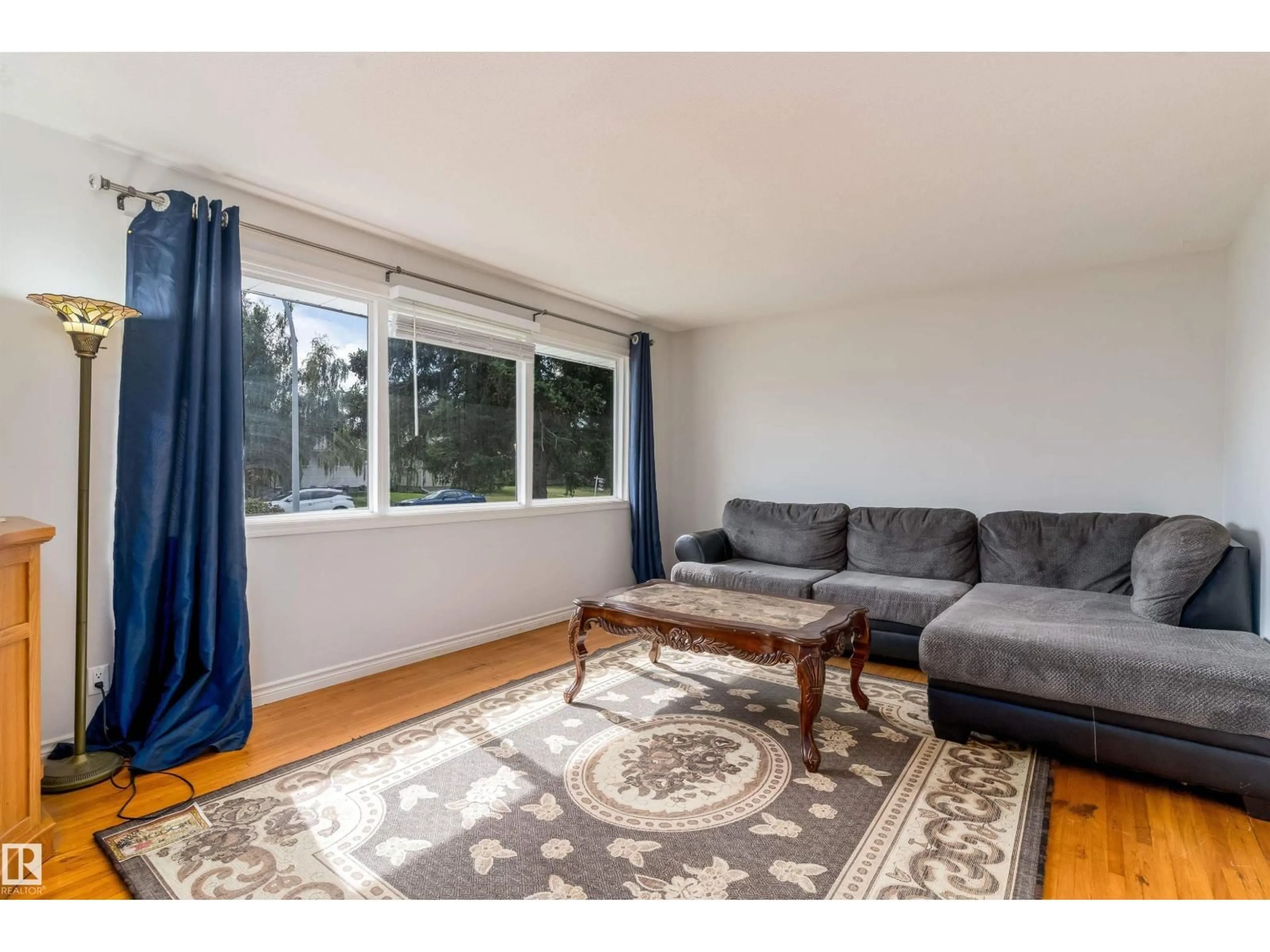 Living room with furniture, wood/laminate floor for NW - 10762 164 ST, Edmonton Alberta T5P3R9