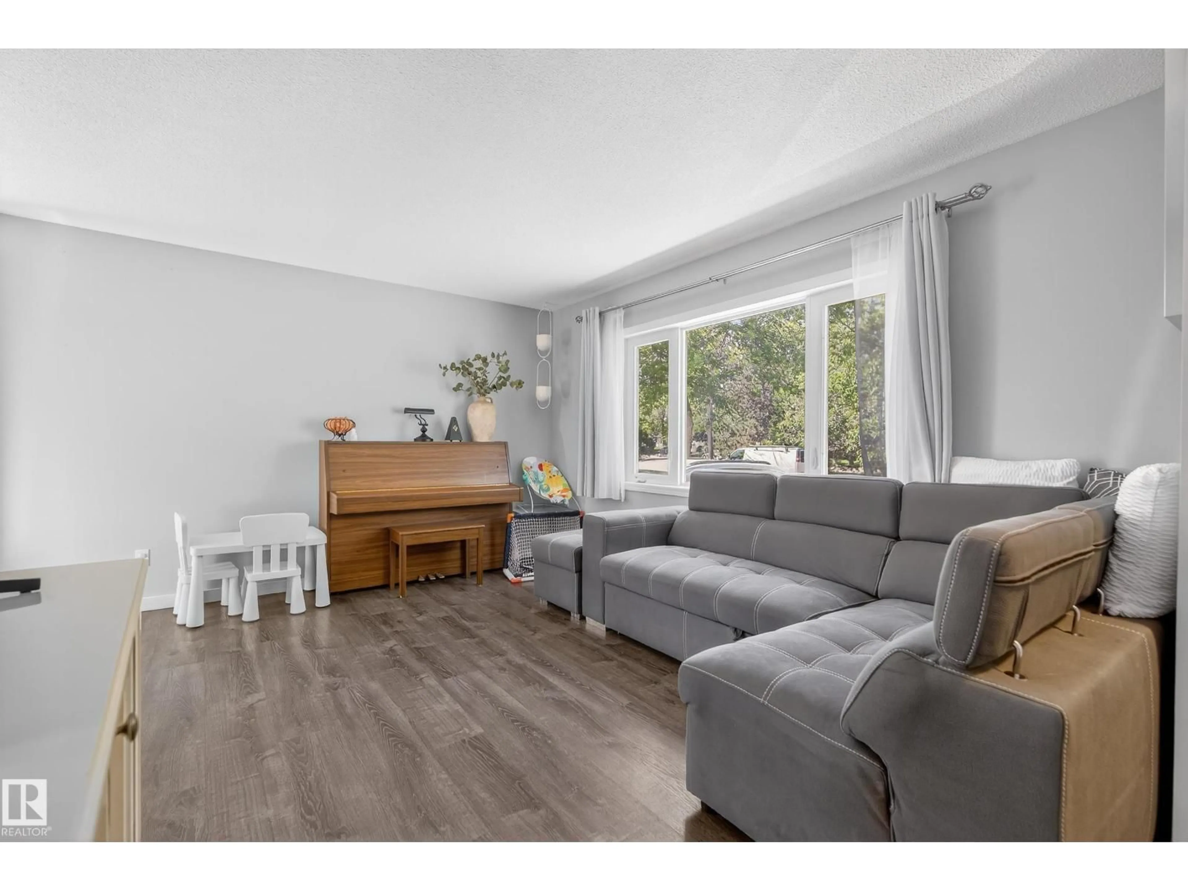 Living room with furniture, wood/laminate floor for 8937 92 AV, Fort Saskatchewan Alberta T8L1A3