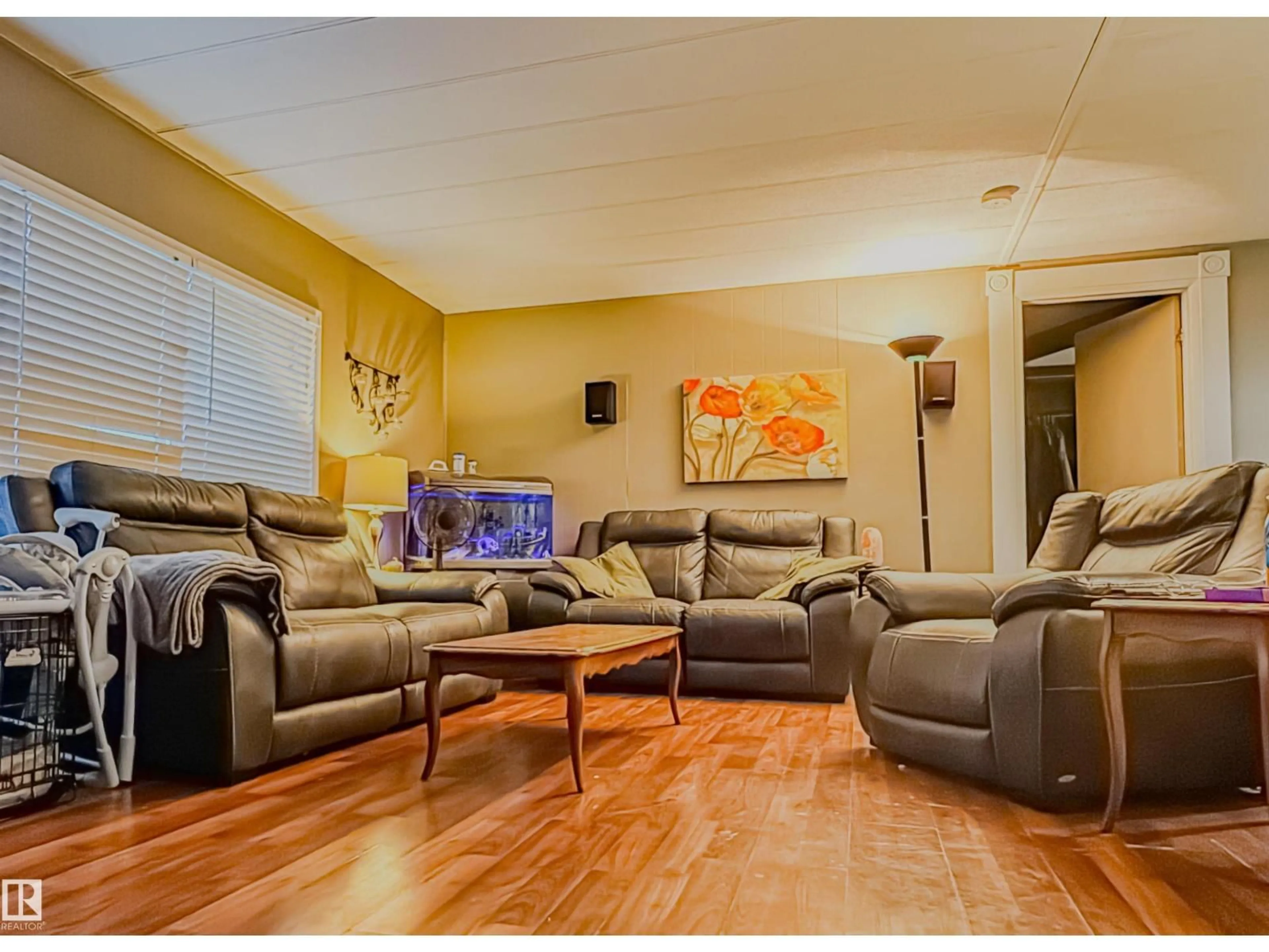 Living room with furniture, wood/laminate floor for 11111 100A AV, Westlock Alberta T7P1N4