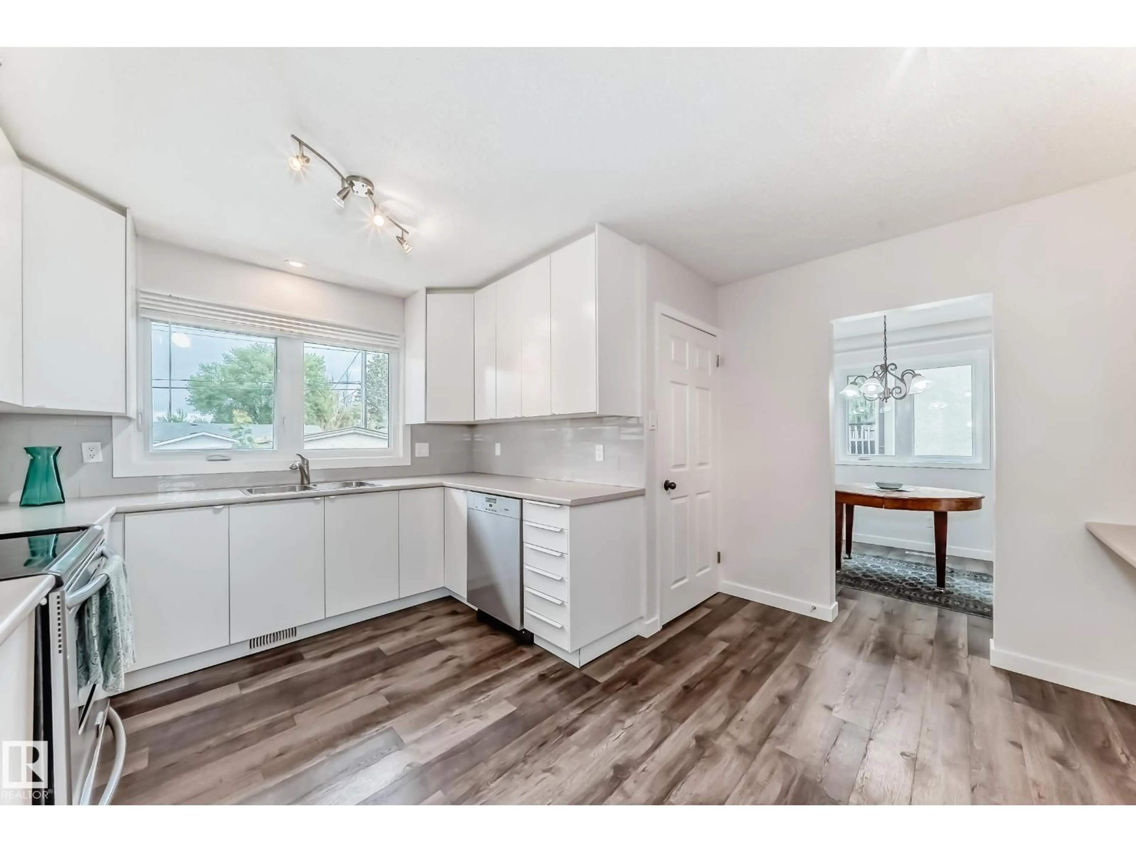 Open concept kitchen, wood/laminate floor for NW - 8415 72 ST, Edmonton Alberta T6B1Y3