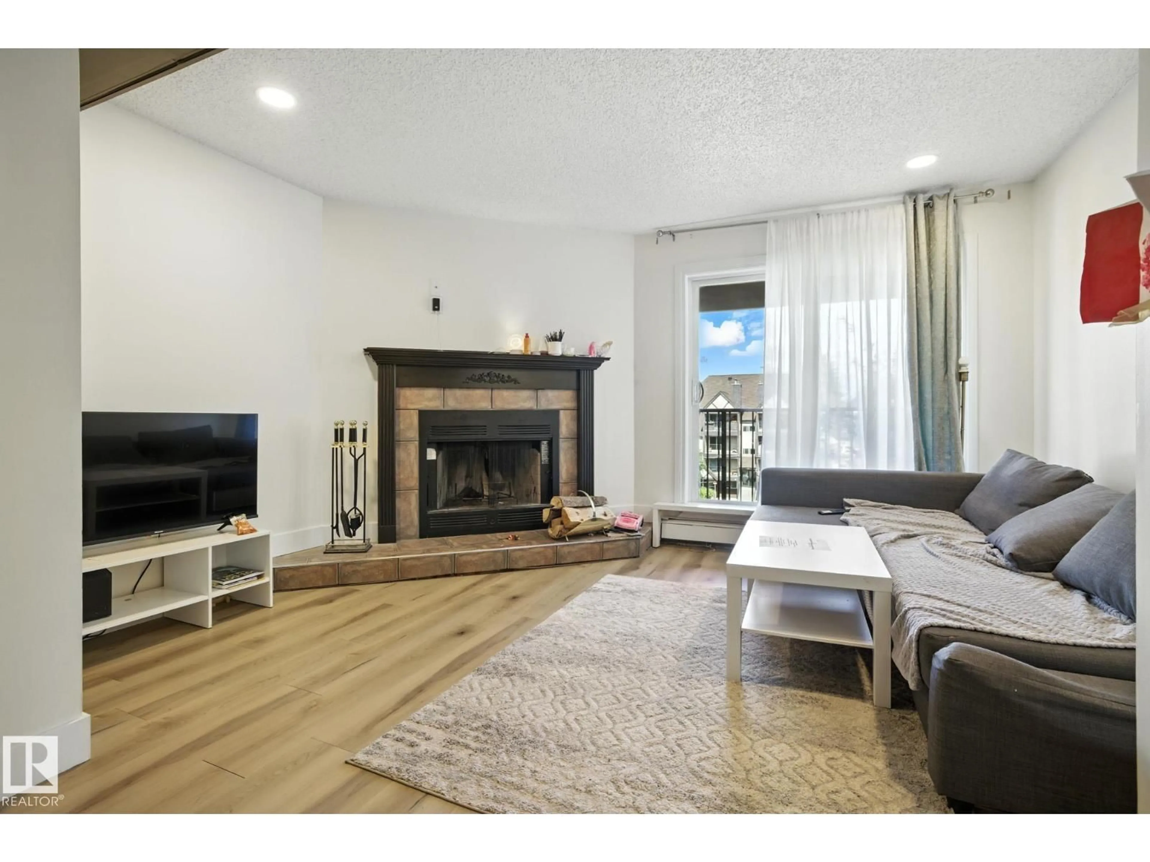 Living room with furniture, wood/laminate floor for 9043 TUDOR GL, St. Albert Alberta T8N3V4