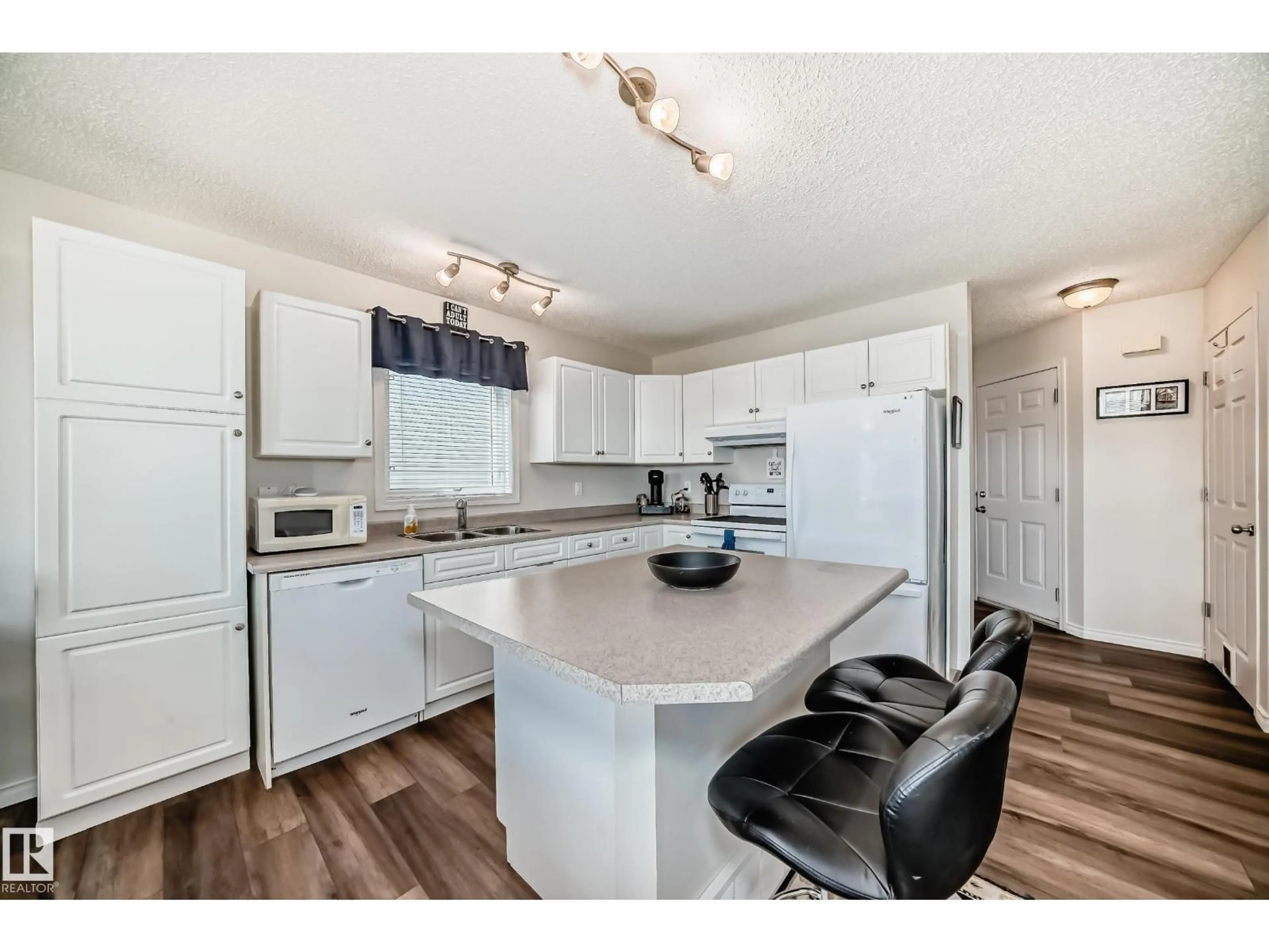 Open concept kitchen, wood/laminate floor for 7 - 115 CHESTERMERE DR, Sherwood Park Alberta T8H2W4