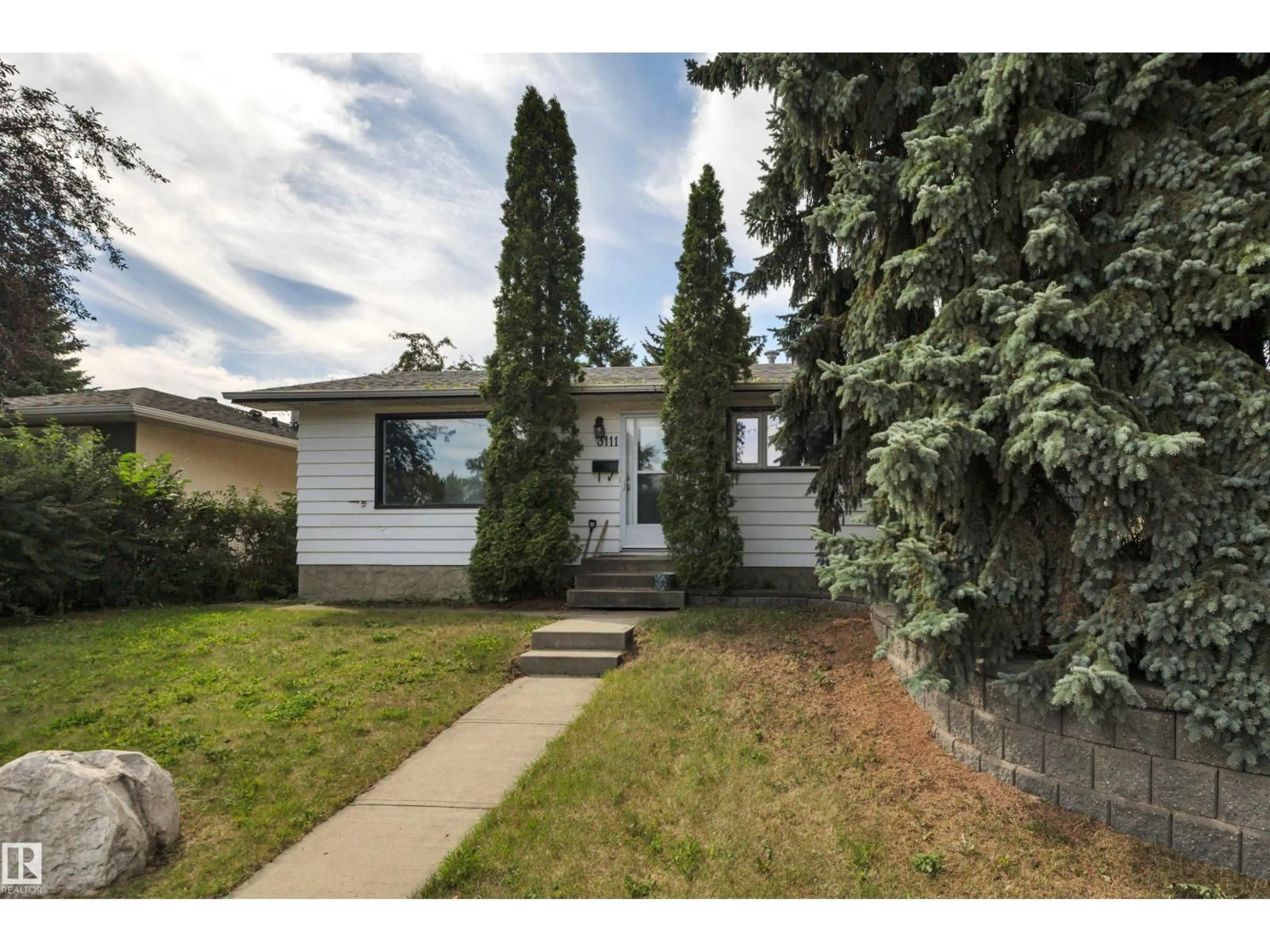 Home with vinyl exterior material, street for 3111 106 AV, Edmonton Alberta T5W0C1