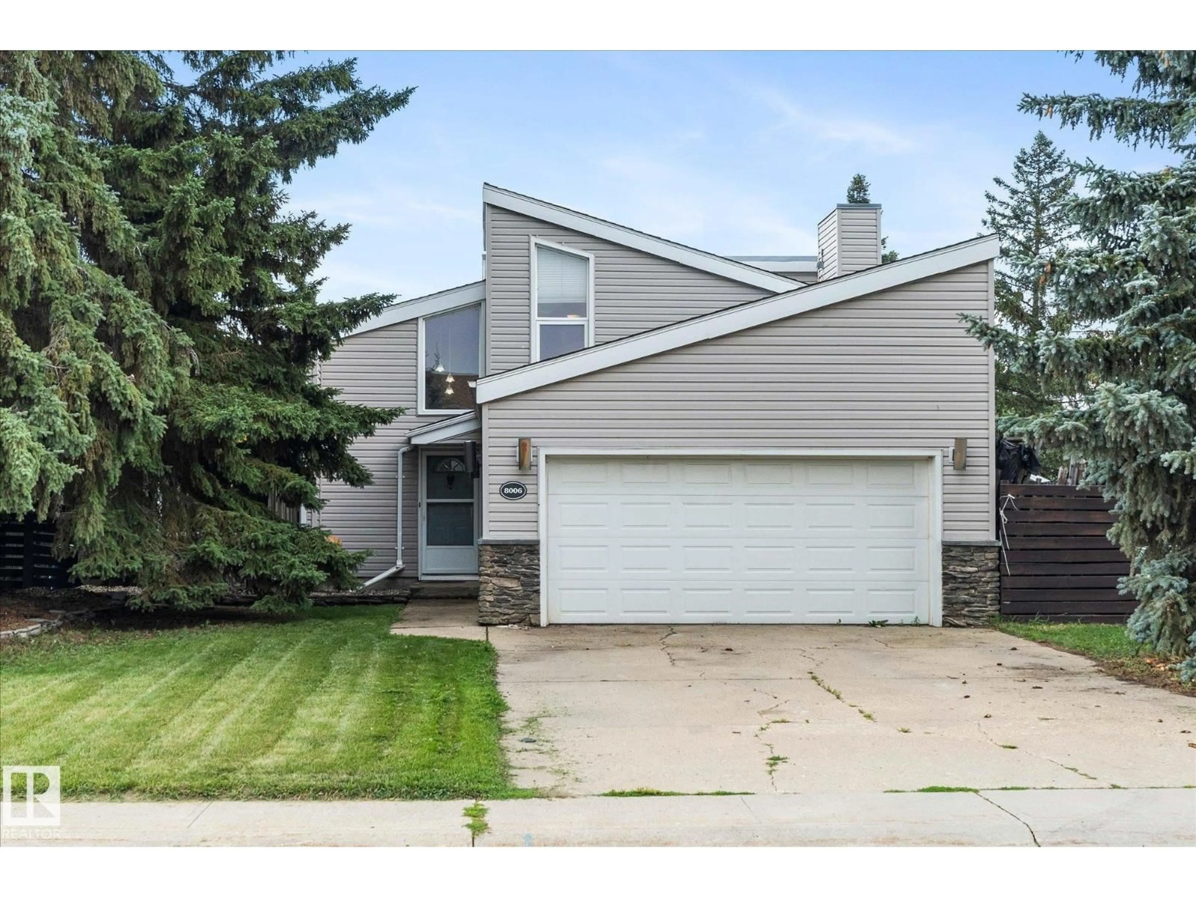 Home with vinyl exterior material, street for 8006 100 AV, Fort Saskatchewan Alberta T8L3K3