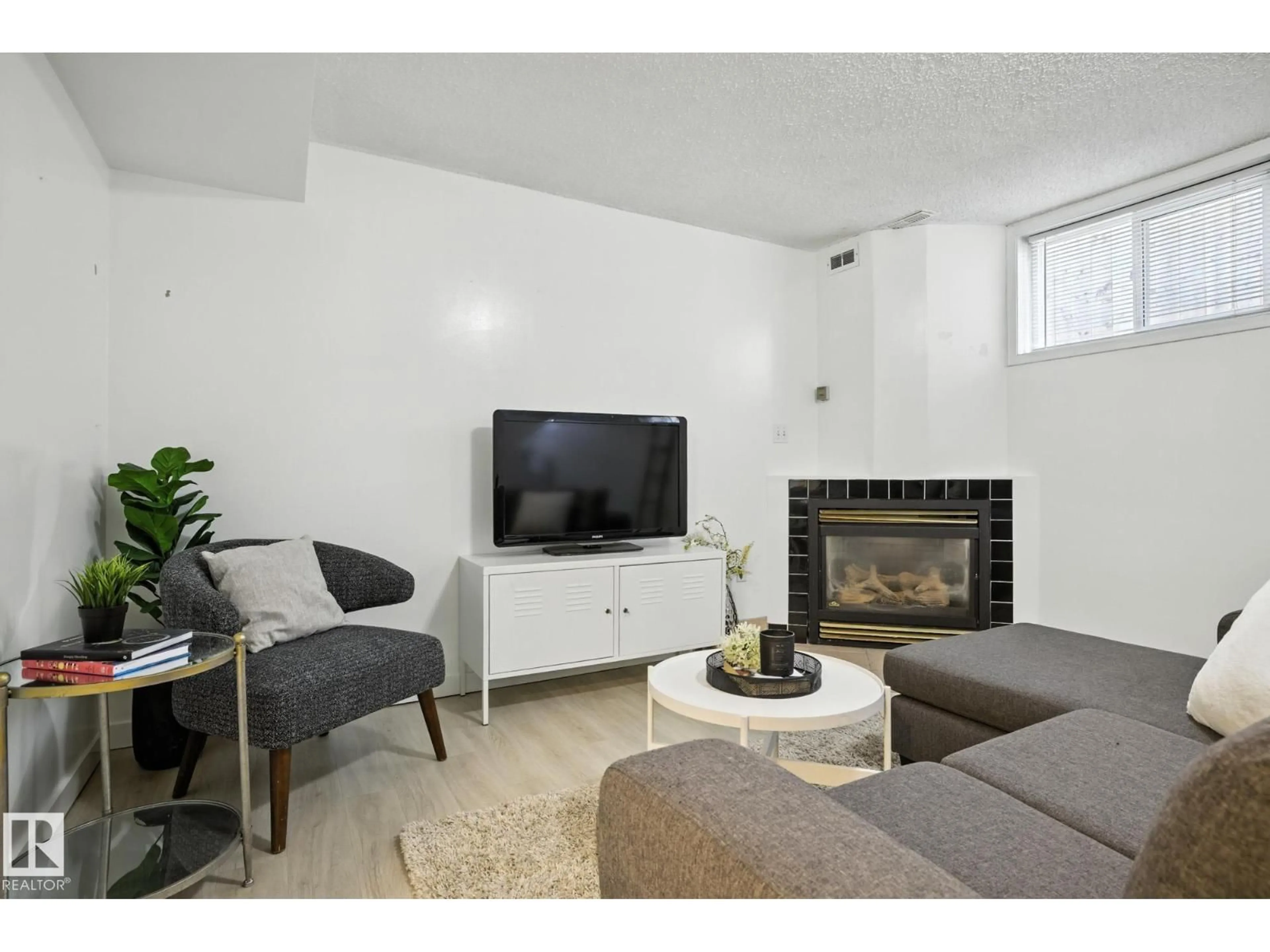 Living room with furniture, unknown for NW - 11112/11116 116 ST, Edmonton Alberta T5G2V6