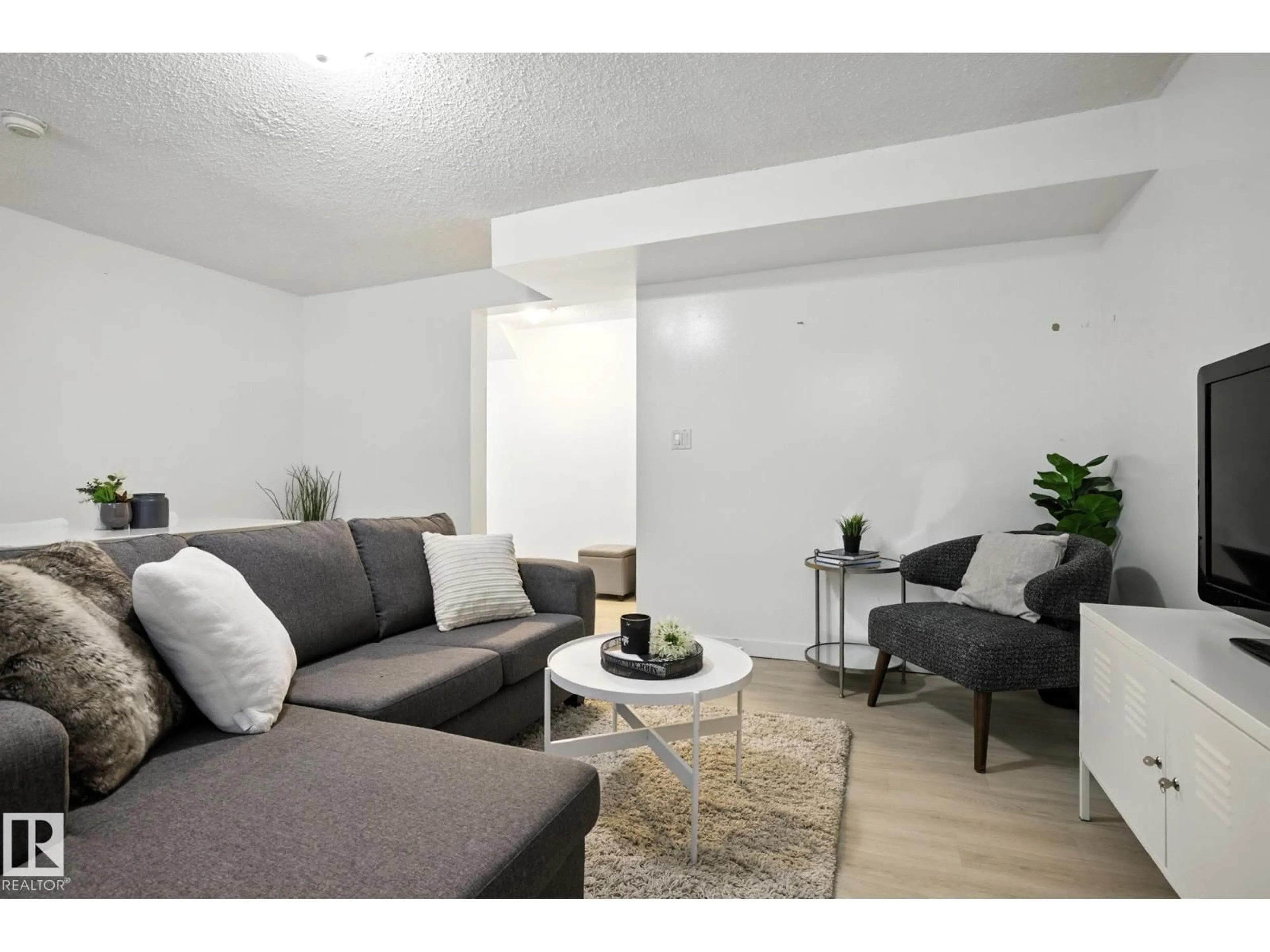 Living room with furniture, unknown for NW - 11112/11116 116 ST, Edmonton Alberta T5G2V6