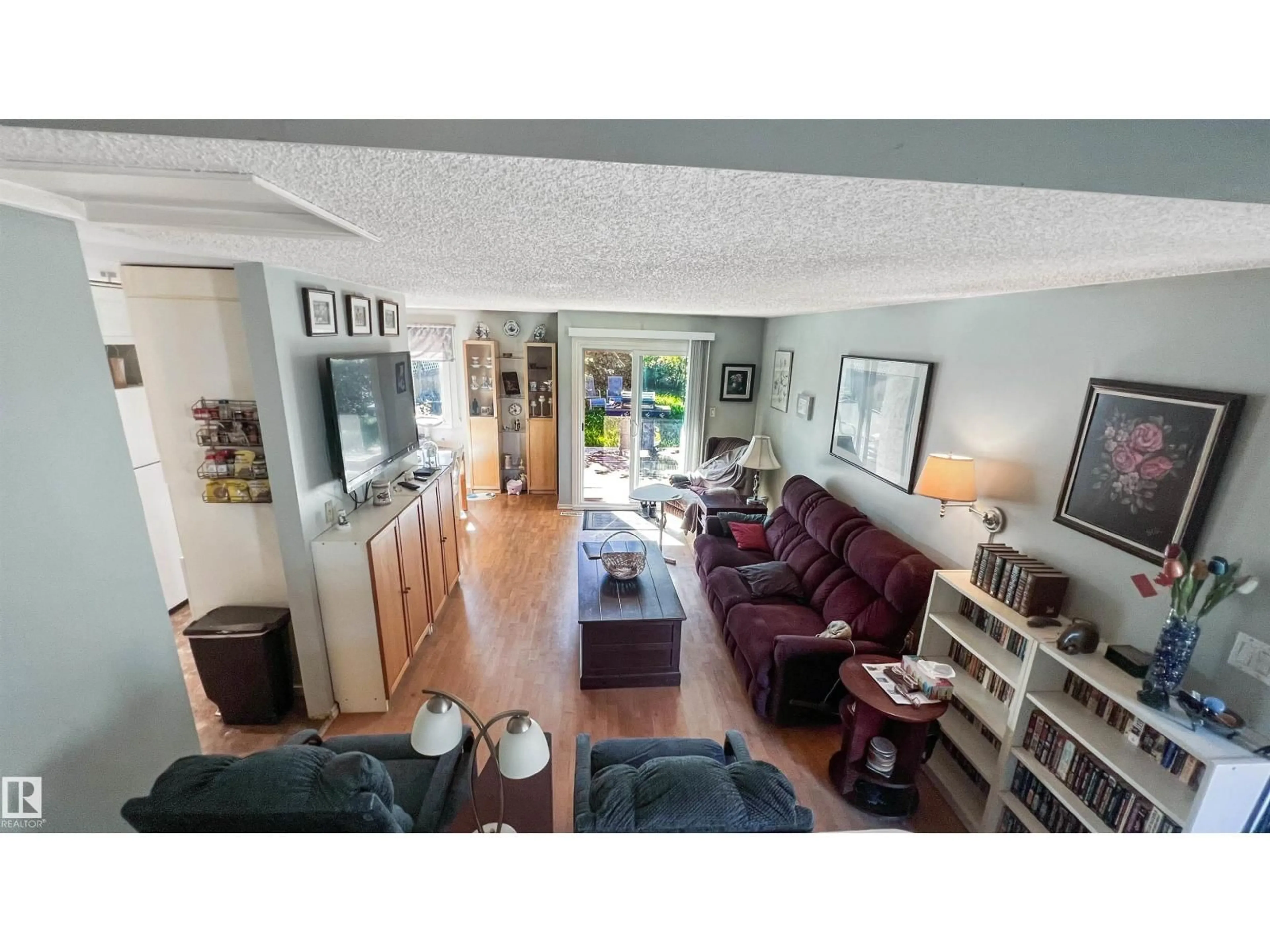 Living room with furniture, wood/laminate floor for 3 GOLD EYE DR, Devon Alberta T9G1W1