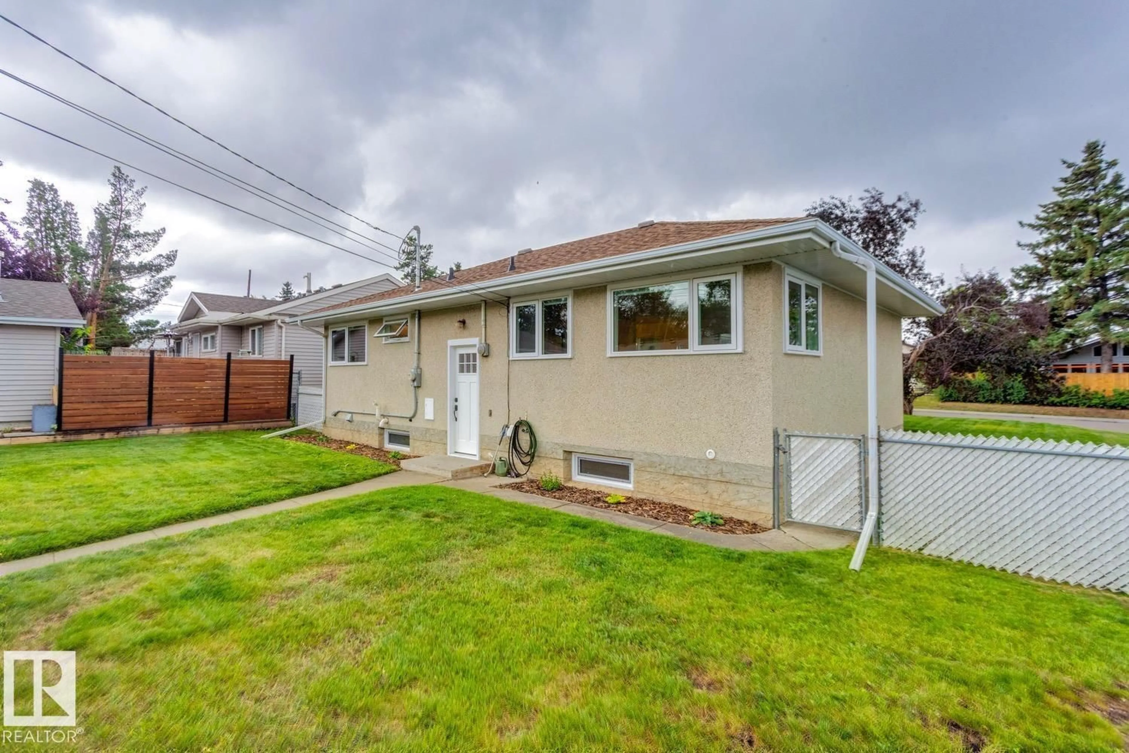 Home with vinyl exterior material, street for 10527 52 ST NW, Edmonton Alberta T6A2G7