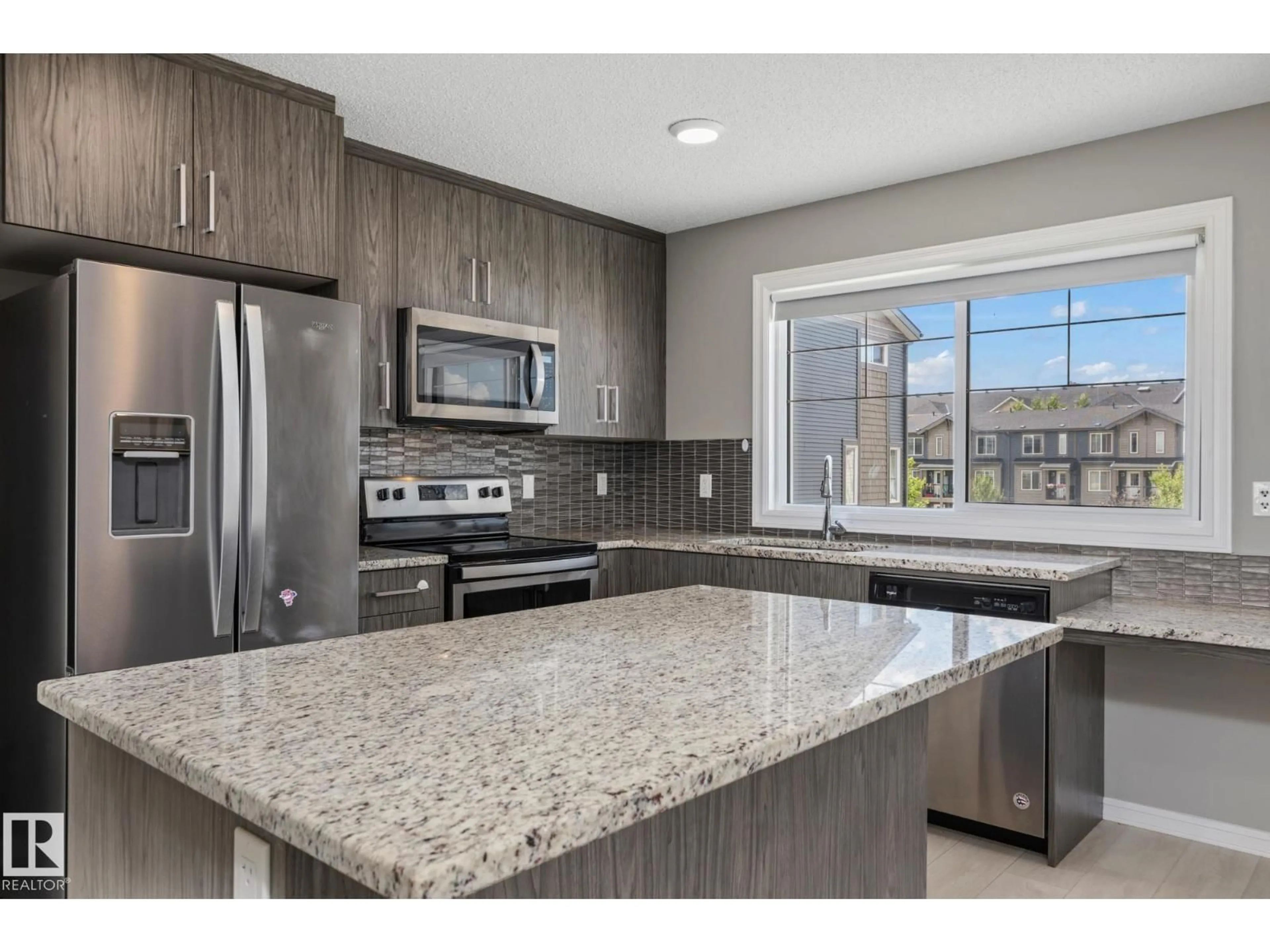 Open concept kitchen, ceramic/tile floor for #2 - 3025 151 AV, Edmonton Alberta T6Y3W4