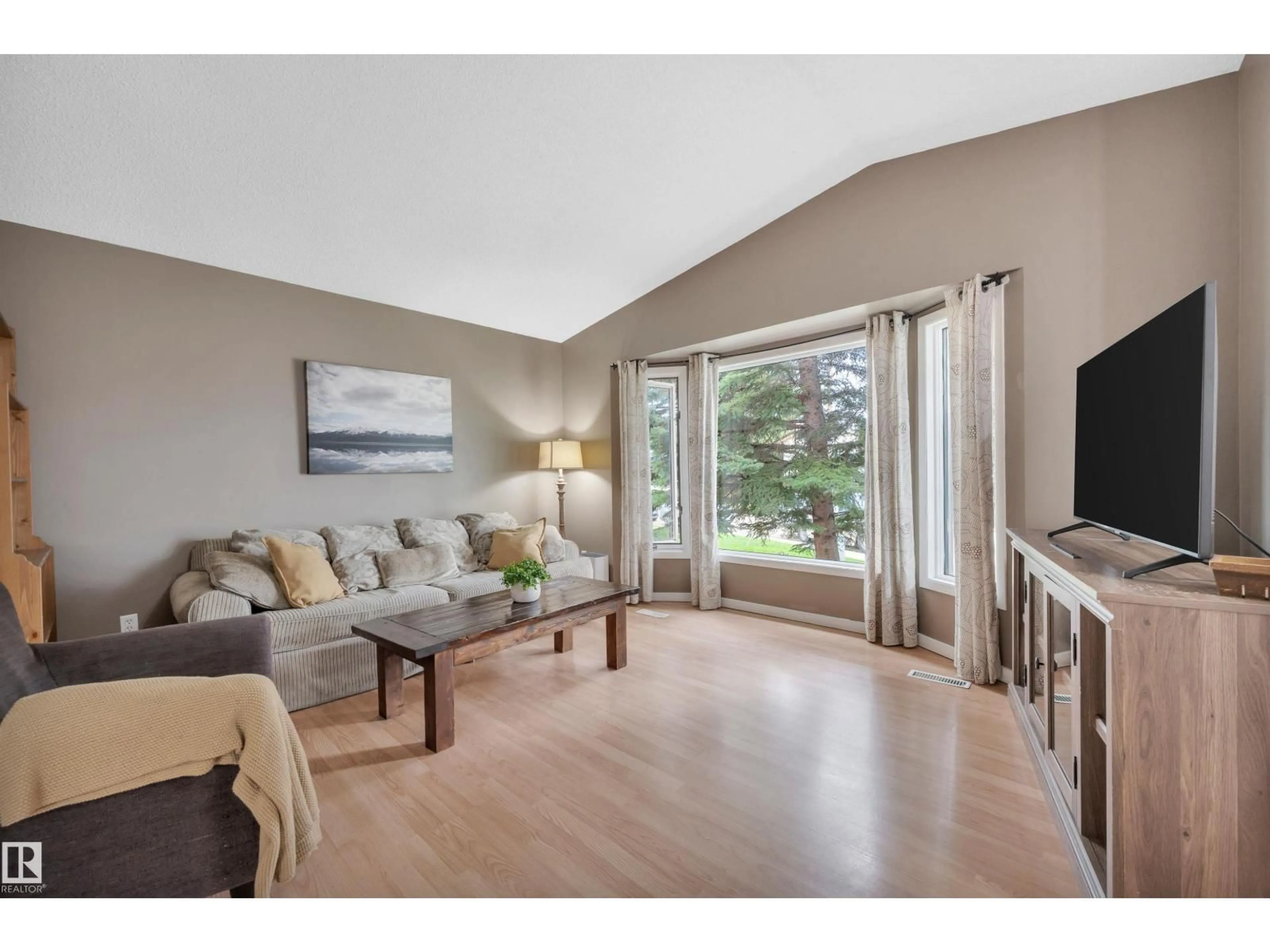 Living room with furniture, wood/laminate floor for 3507 41 AV, Edmonton Alberta T6L5S5