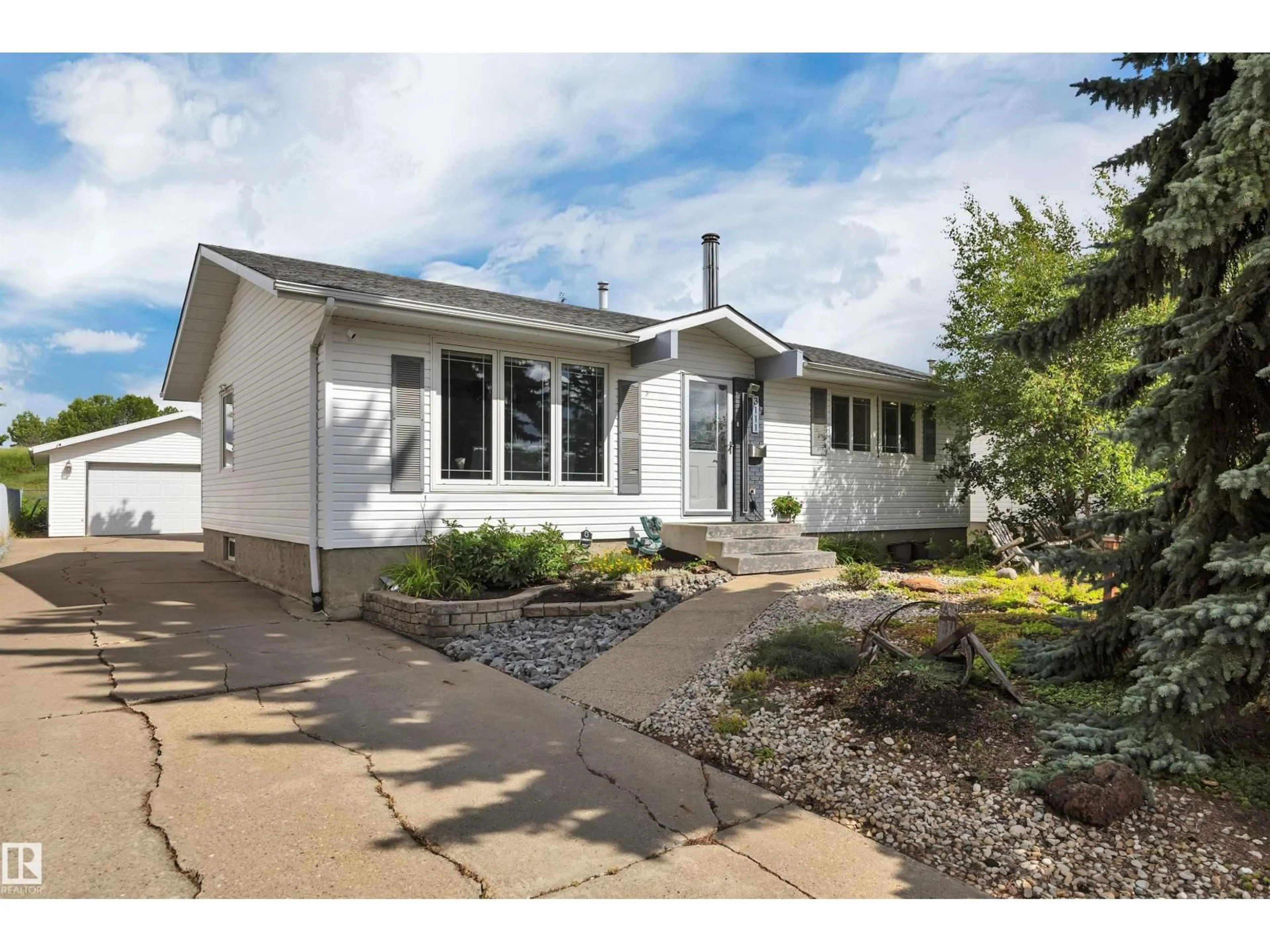 Home with vinyl exterior material, street for 3111 104 ST NW, Edmonton Alberta T6J3B2