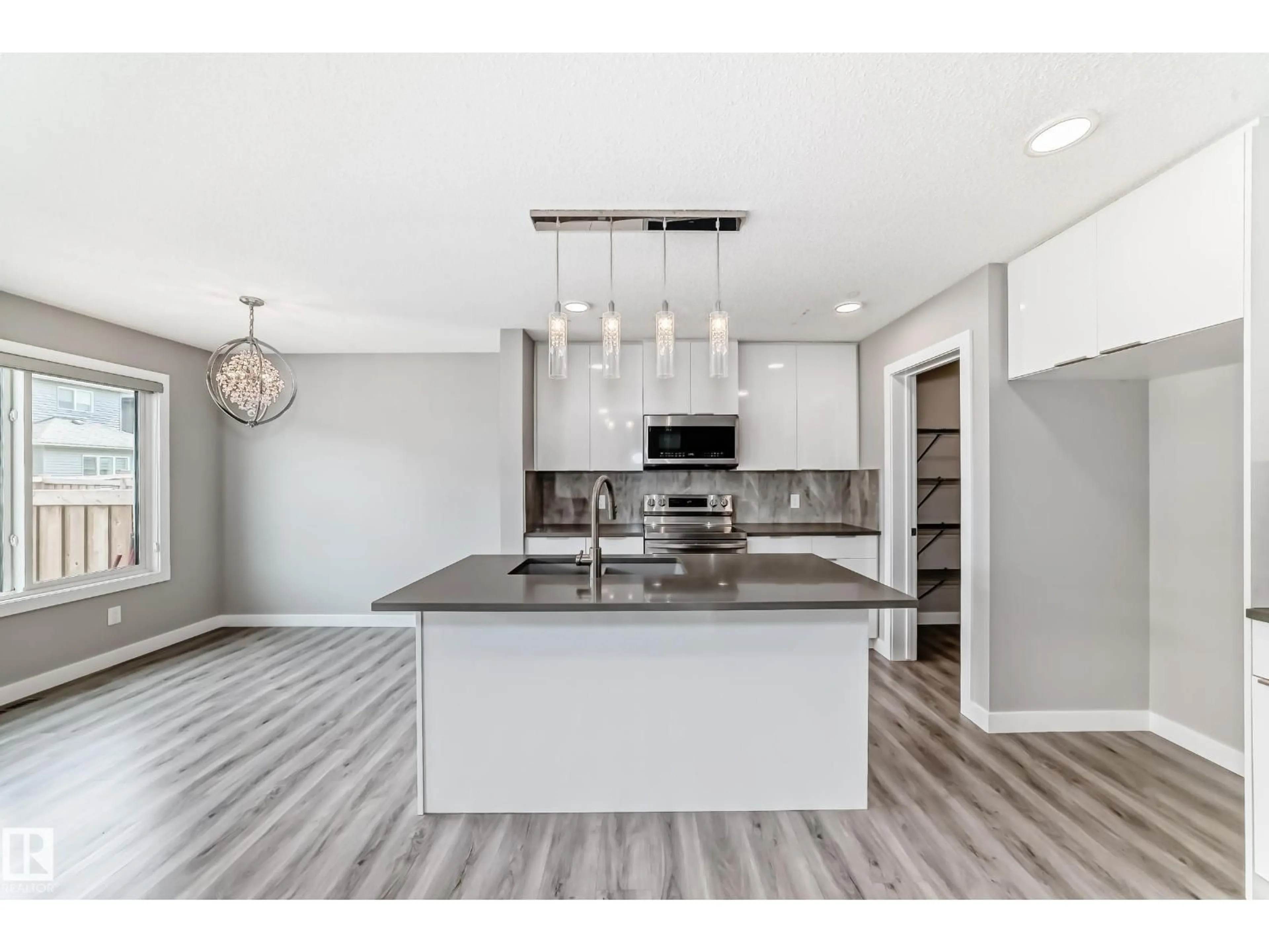 Open concept kitchen, wood/laminate floor for NW - 17513 65 ST, Edmonton Alberta T5Y4A7