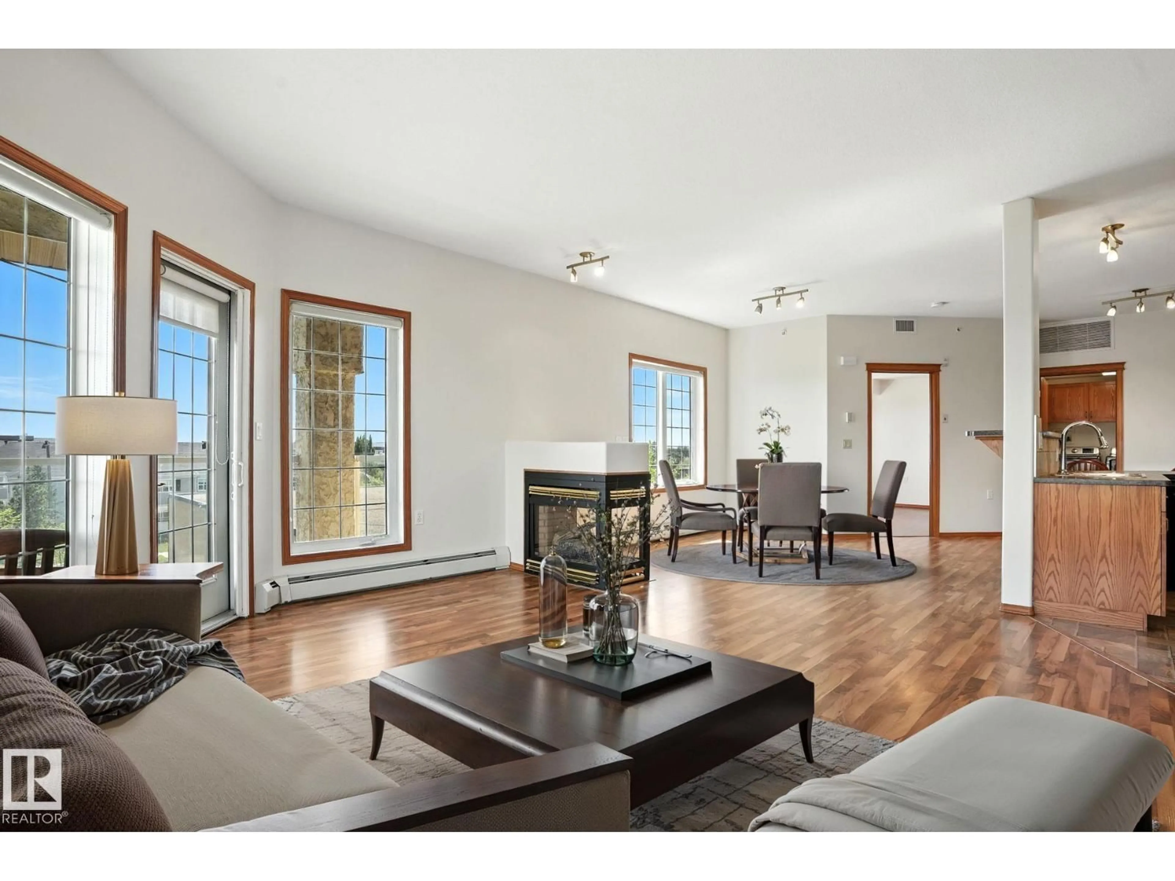 Living room with furniture, wood/laminate floor for 430 - 11260 153 AV NW, Edmonton Alberta T5X6E7