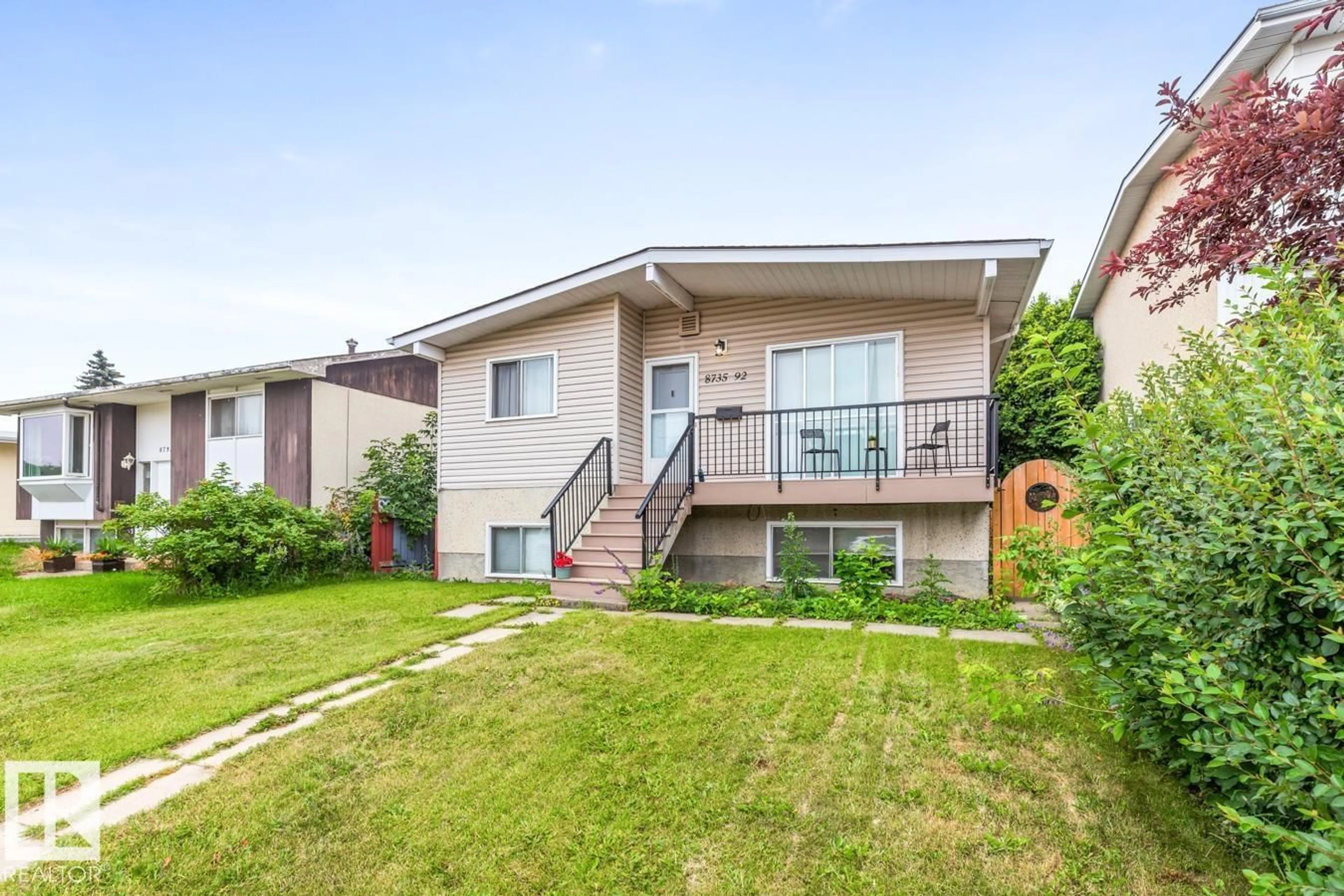Home with vinyl exterior material, street for 8735 92 AV, Edmonton Alberta T6C1S2