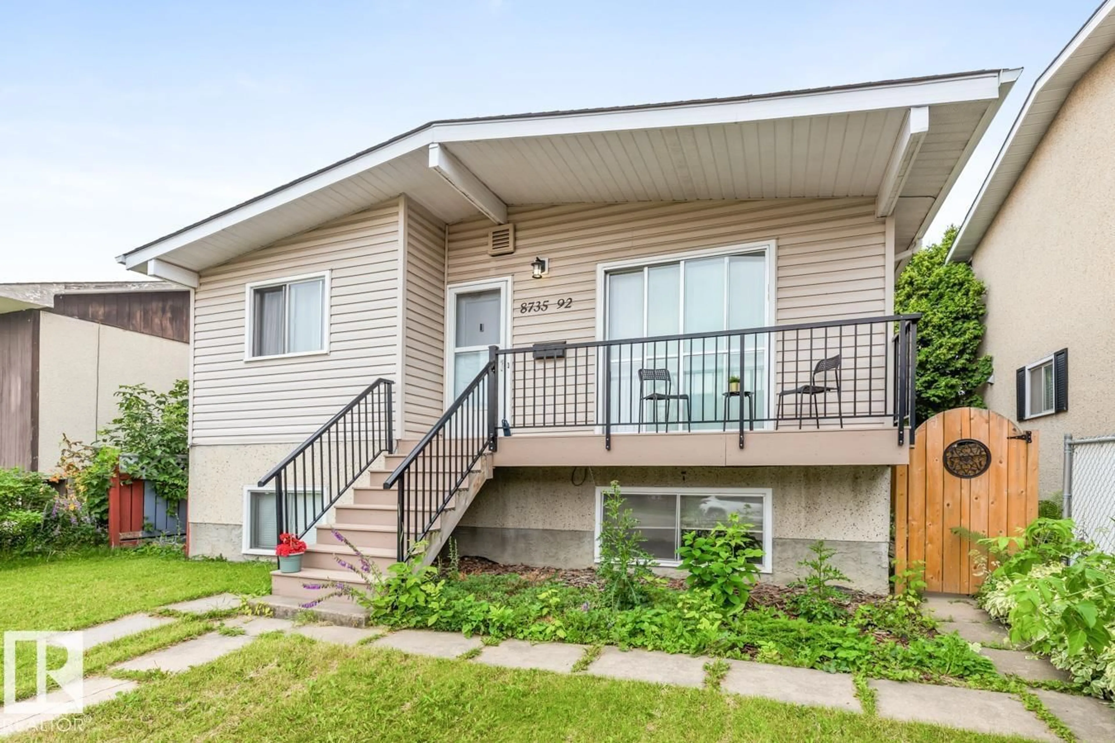 Home with vinyl exterior material, street for 8735 92 AV, Edmonton Alberta T6C1S2