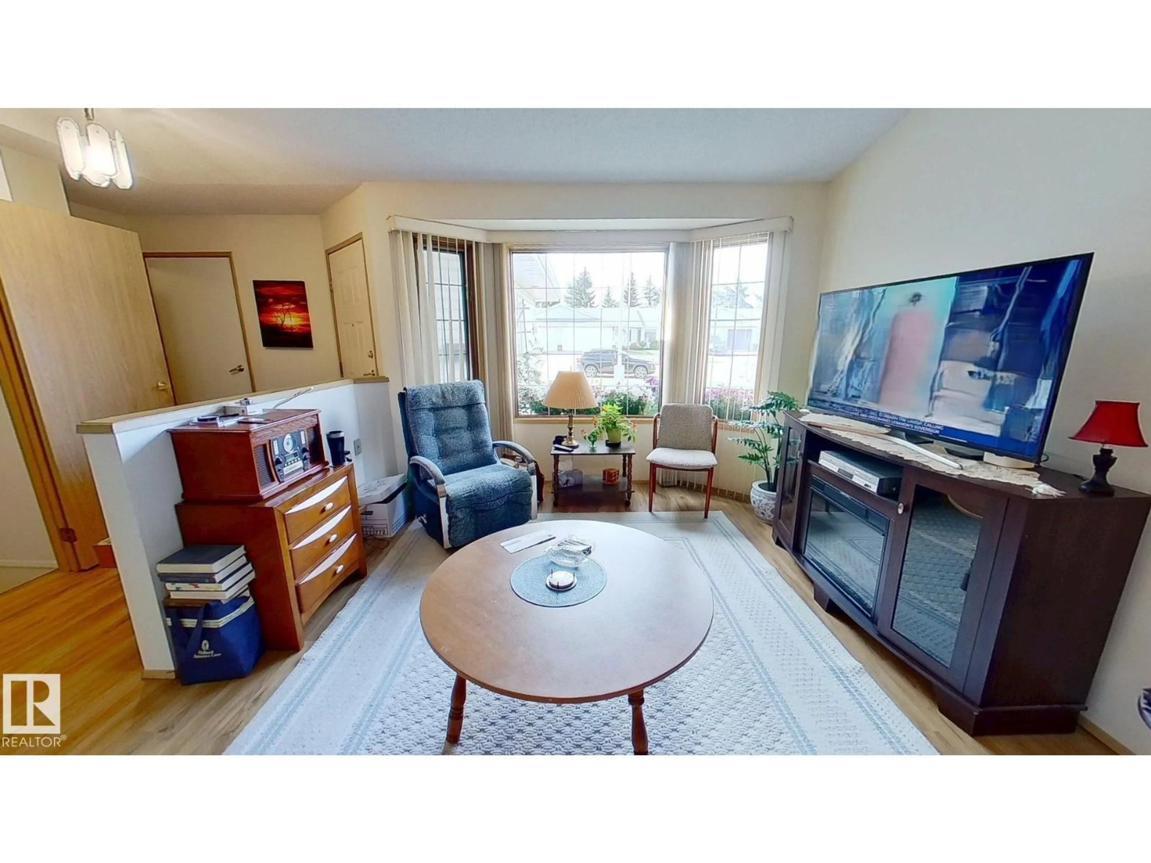 Living room with furniture, wood/laminate floor for 7528 137A AV, Edmonton Alberta T5C3R4