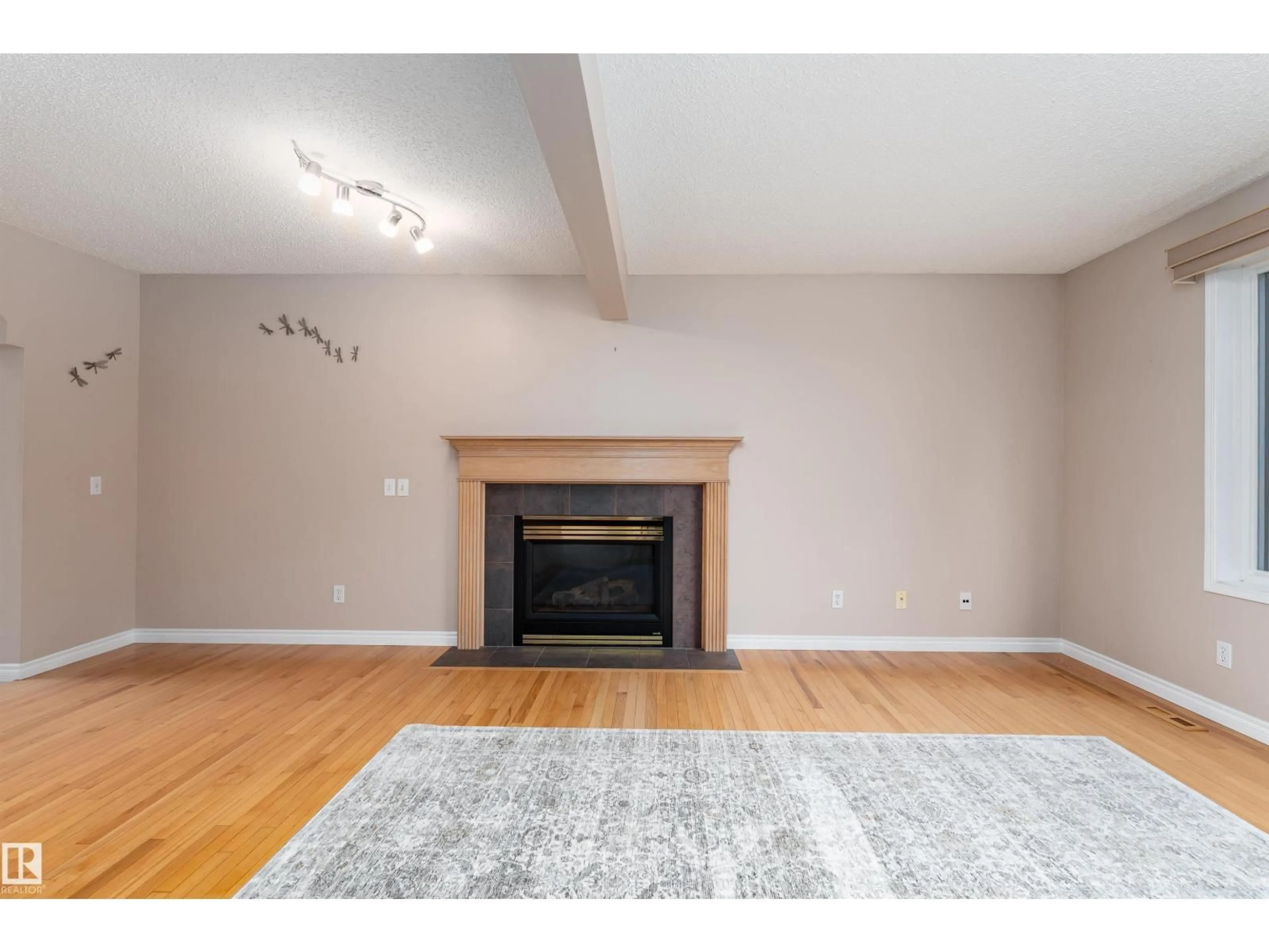 Living room with furniture, wood/laminate floor for NW - 8823 188 ST, Edmonton Alberta T5T5Z8